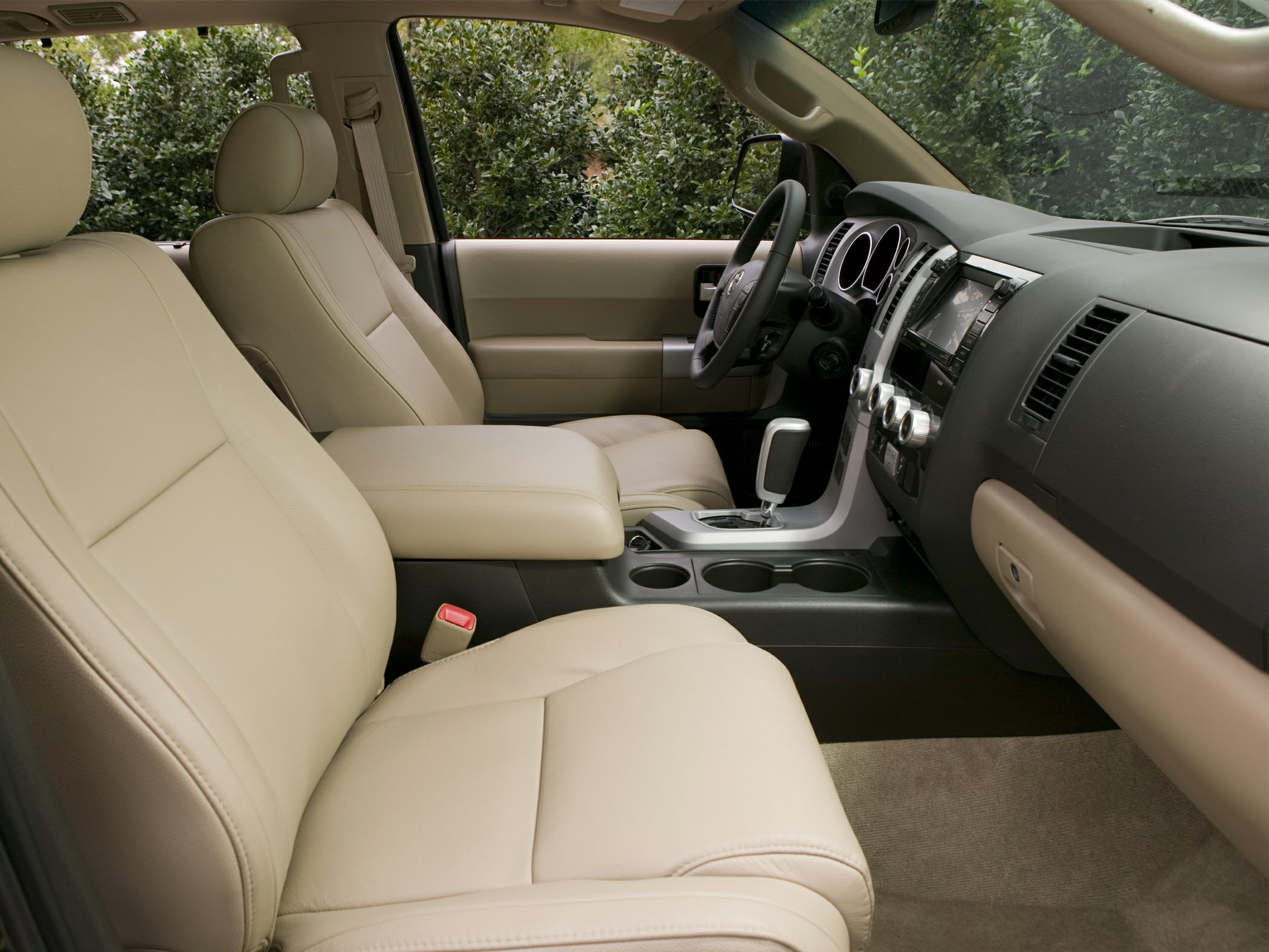 Beige leather seats and center console with dashboard and controls