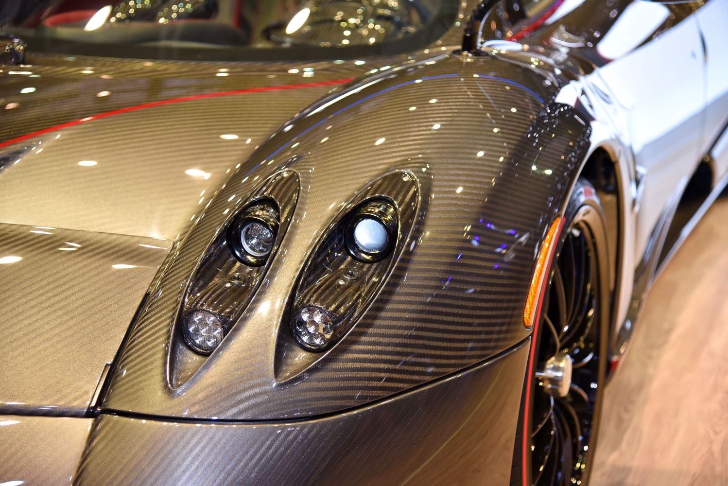 Close-up of carbon fiber hood and dual headlight assembly