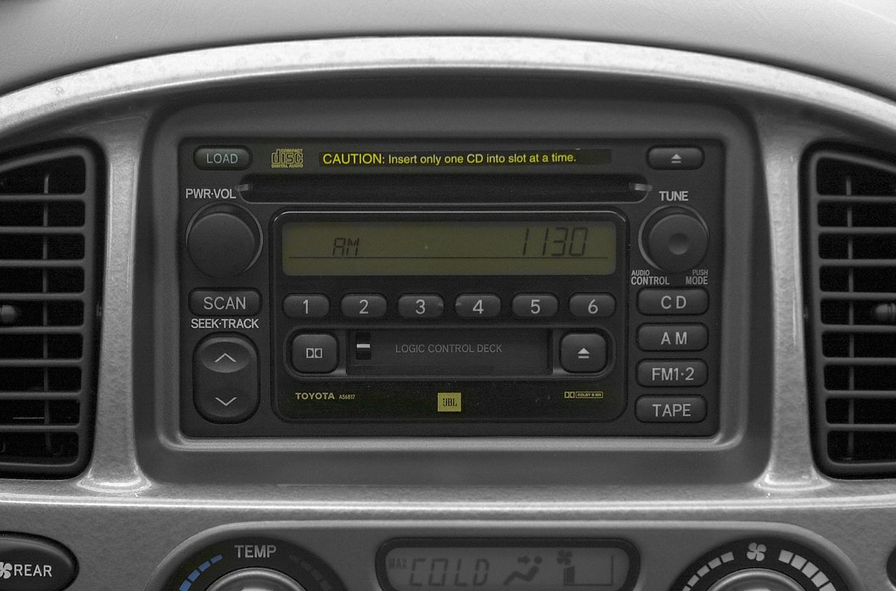 Close-up of vintage car stereo with cassette, CD player, and radio controls