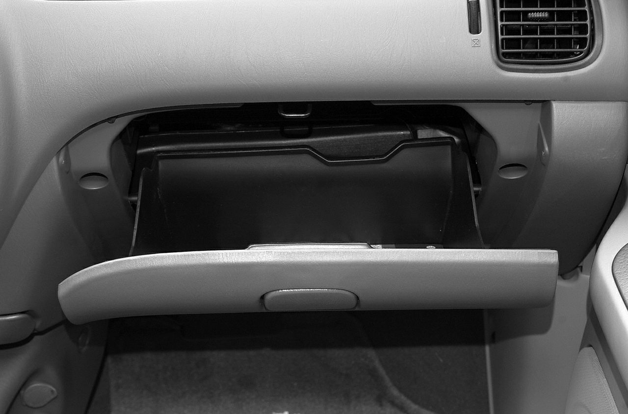 Open glove box compartment inside car dashboard