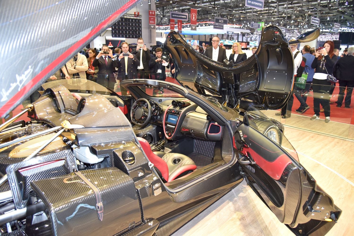 Open luxury roadster interior with carbon fiber detailing and exposed body panels