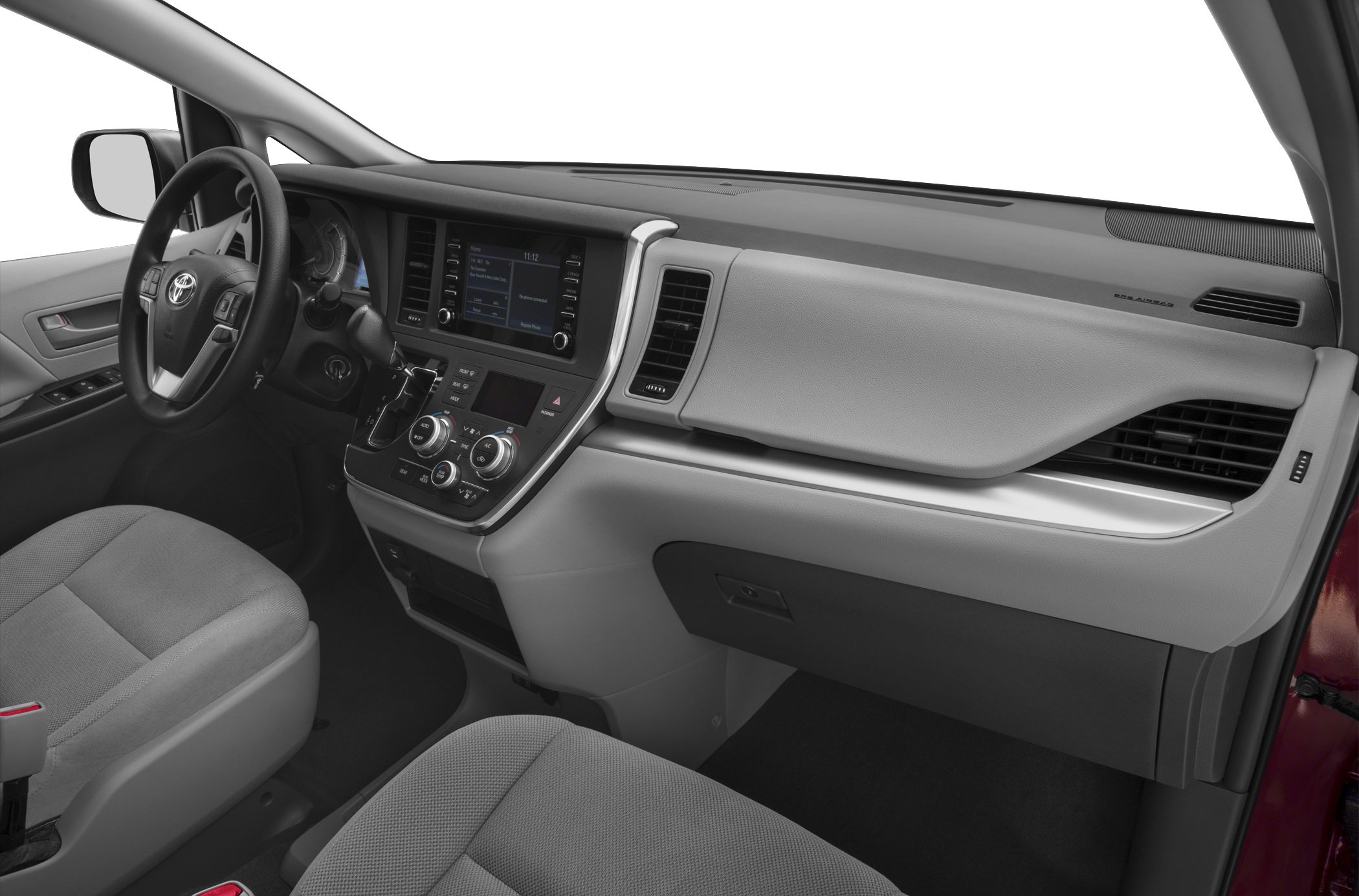 Dashboard, steering wheel, and infotainment controls in a minivan interior