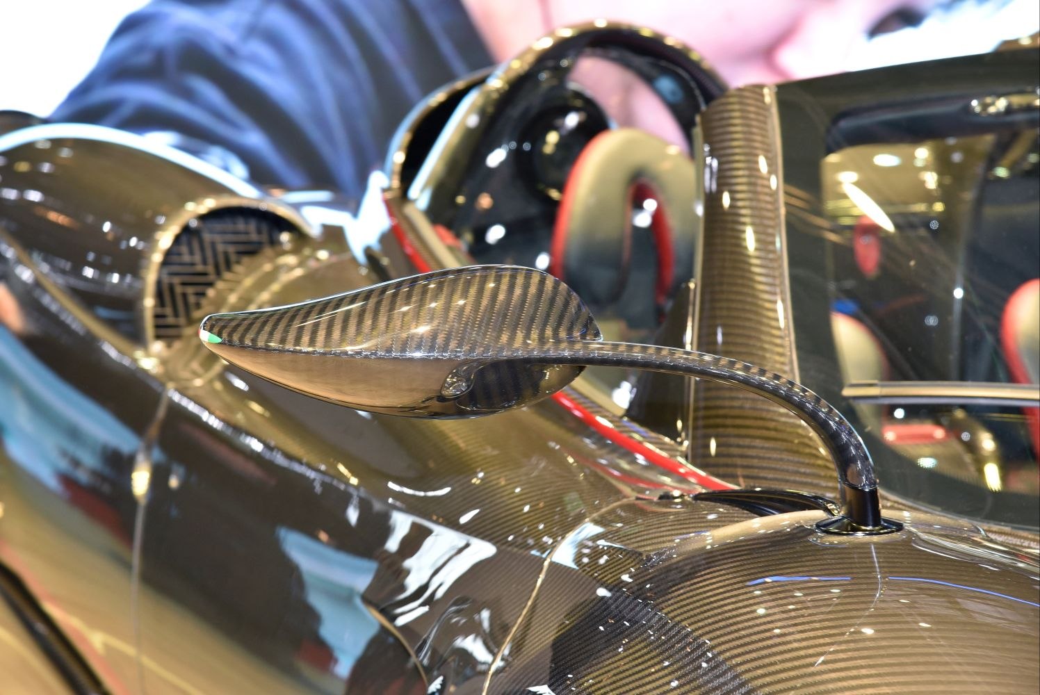 Carbon fiber aerodynamic side mirror with vehicle interior visible