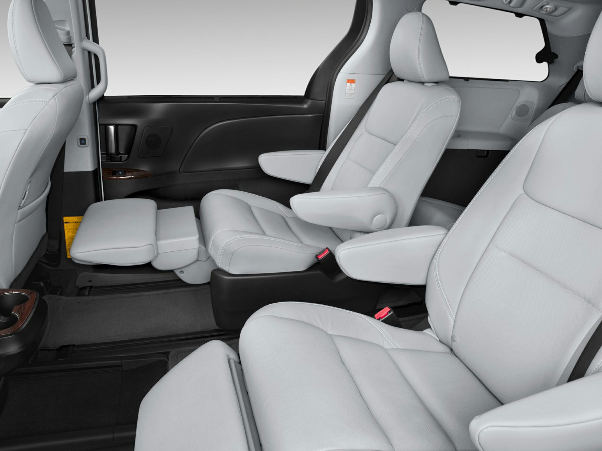Captain seats with leg rests and armrests inside a vehicle