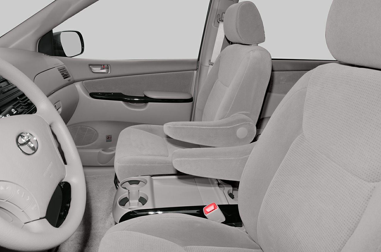 Front seats with armrests, dashboard, steering wheel, and door panel