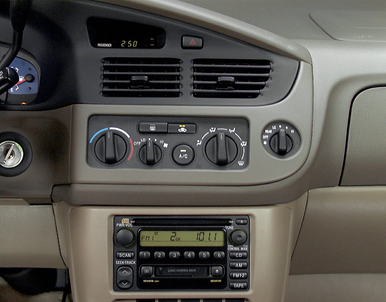Dashboard climate controls and factory radio unit with knobs and digital display.