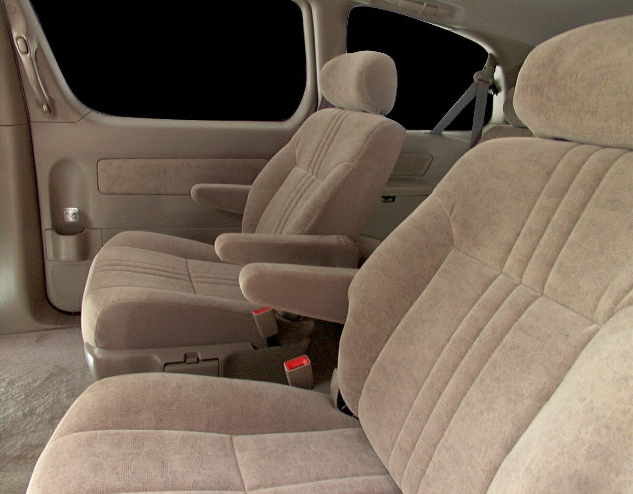 Beige fabric seats with armrests in spacious second-row minivan interior