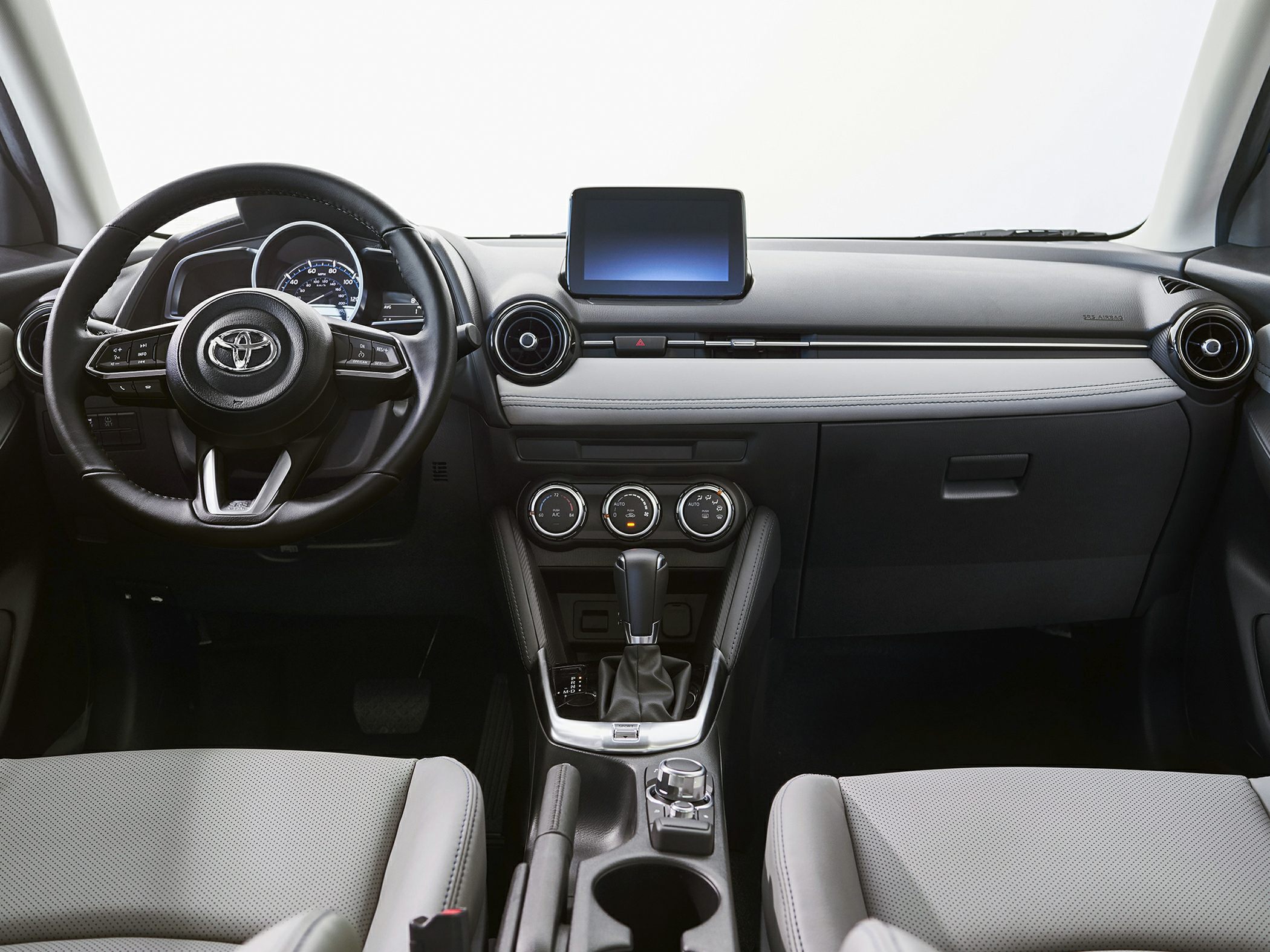 Modern dashboard with digital screen, multifunction steering wheel, and circular air vents