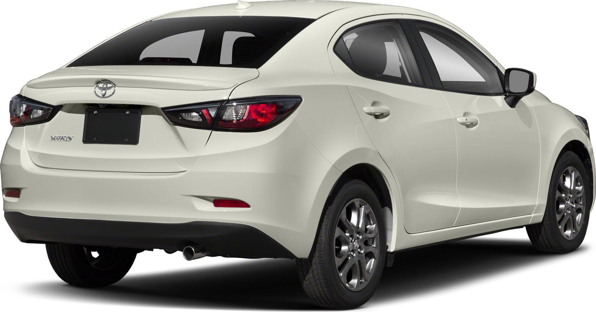 Rear and side view of a compact sedan with illuminated taillights and alloy wheels