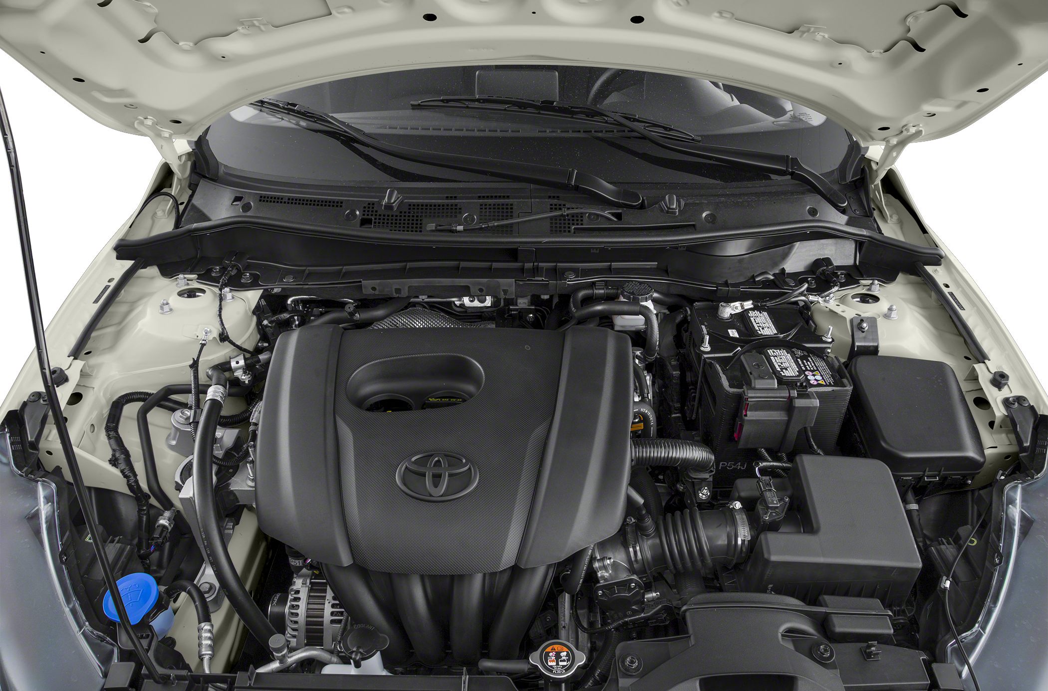 Close-up of a compact sedan engine bay with engine cover and battery.