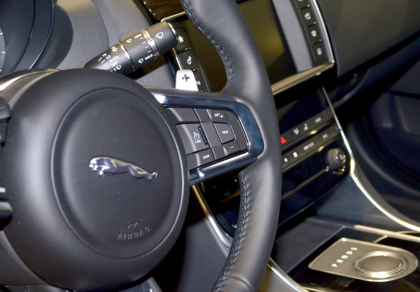 Jaguar XE steering wheel with control buttons and center console gear selector