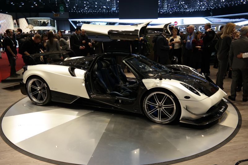 Black and white supercar with gullwing doors and carbon fiber body
