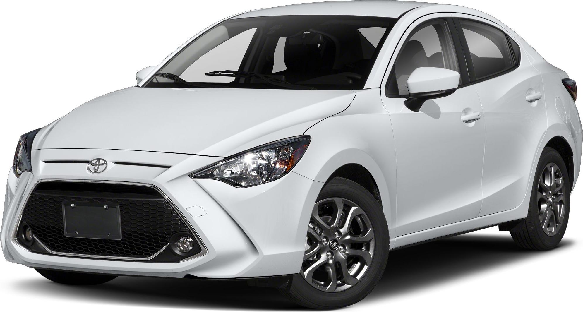 Front grille, headlights, wheels, and side profile of a white sedan.