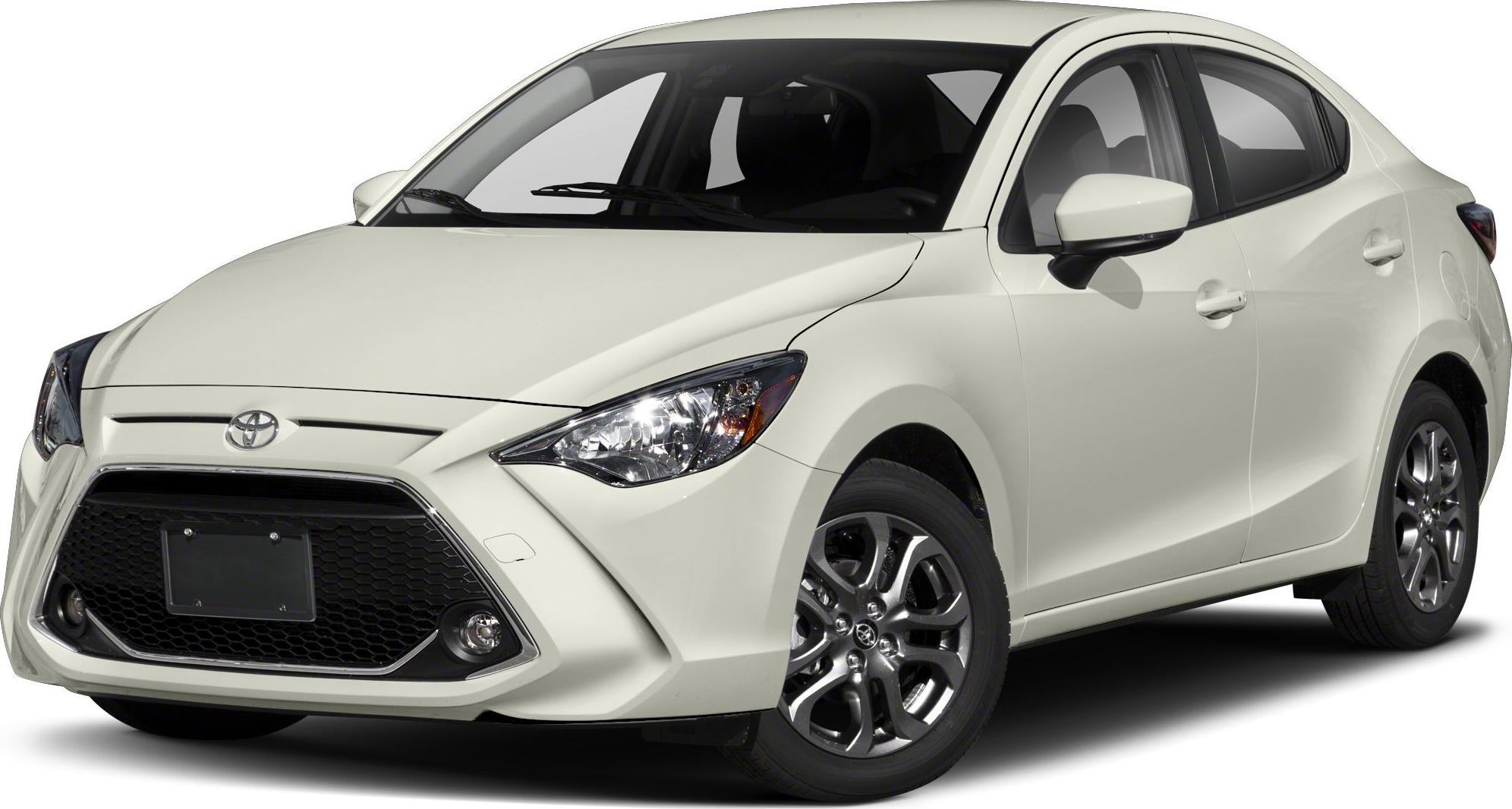 Compact sedan front three-quarter with large hexagonal grille and sharp headlamps