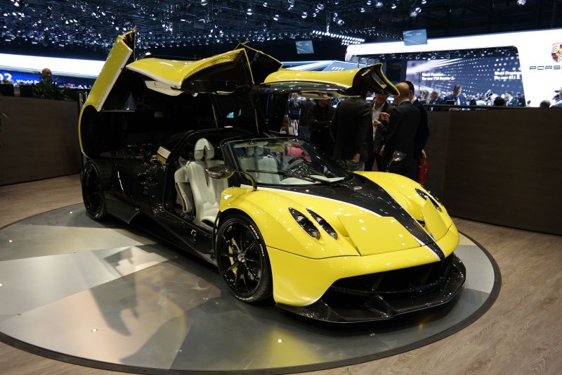 Yellow and black supercar with gullwing doors and carbon fiber accents
