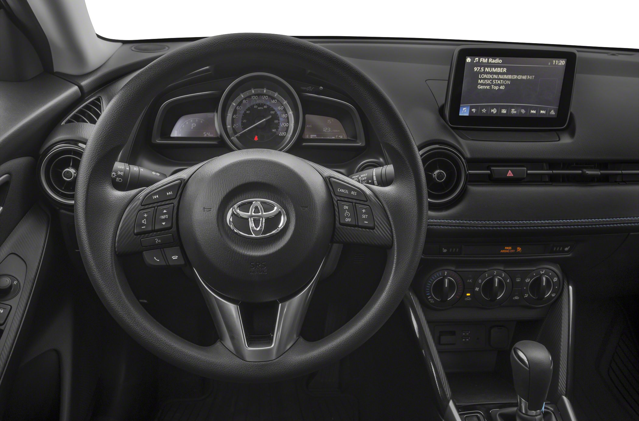 Steering wheel, dashboard, and infotainment display with climate controls and gear shifter