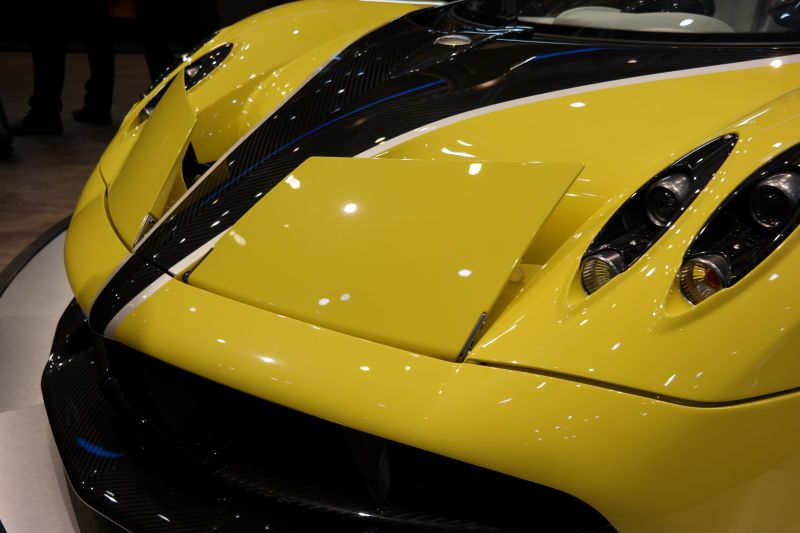 Close-up of front hood and quad headlights with carbon fiber.