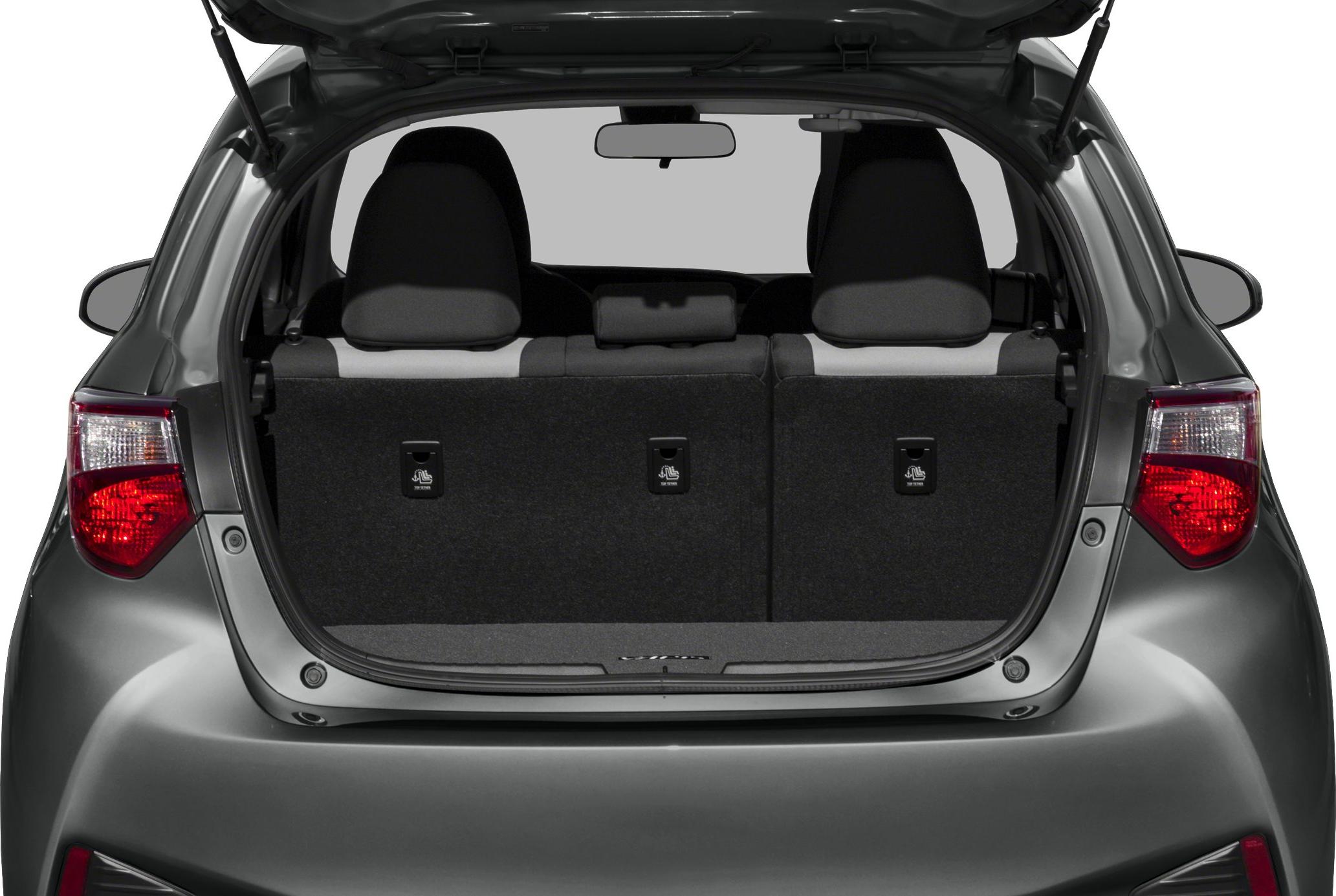 Rear cargo space and foldable rear seats inside a hatchback.