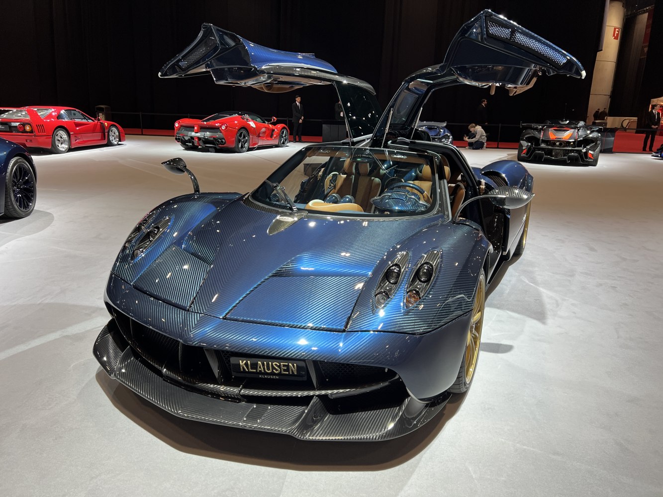 Gullwing doors open on carbon fiber supercar with gold wheels
