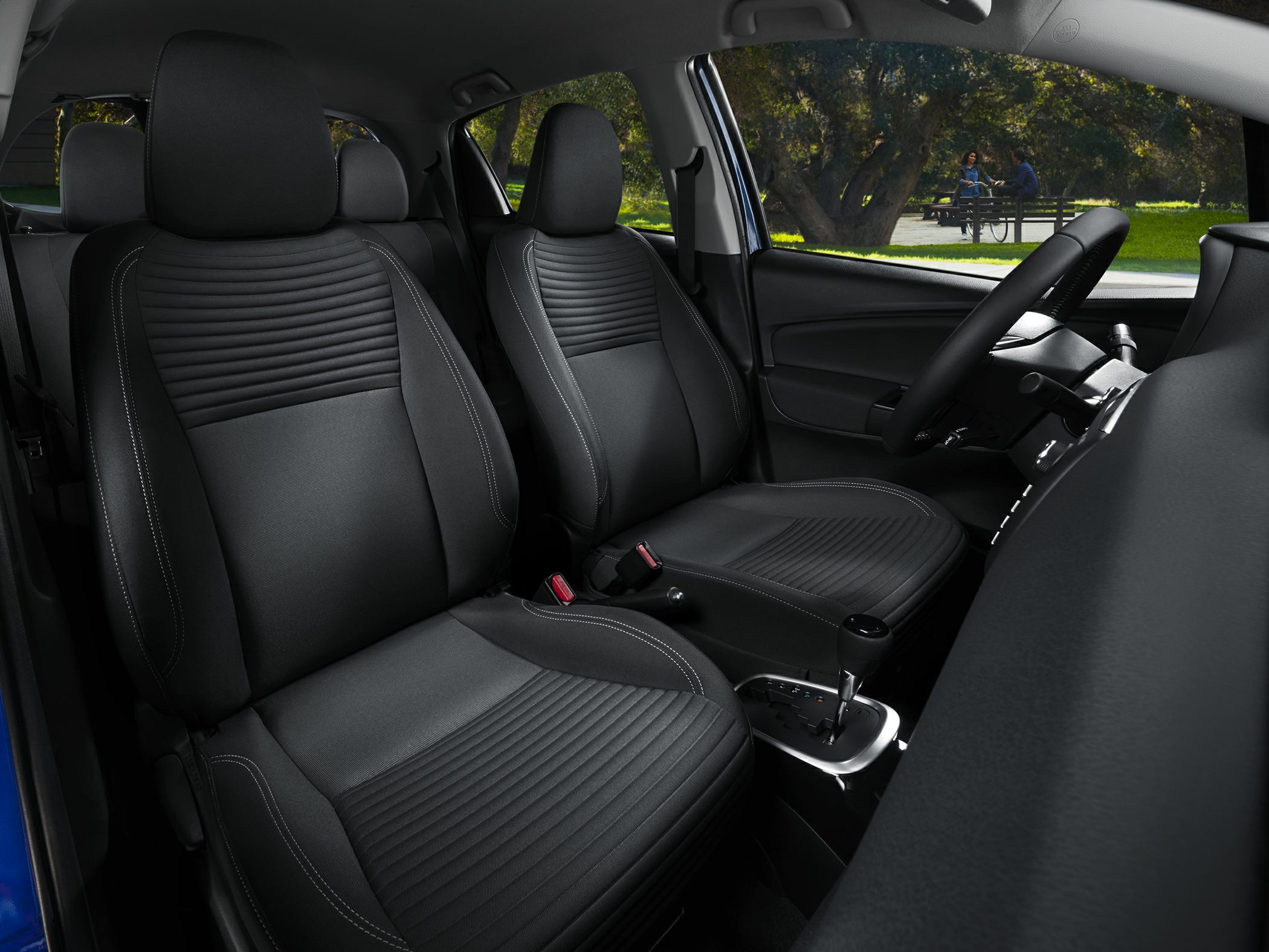Front seats and gear shift lever of a compact car interior