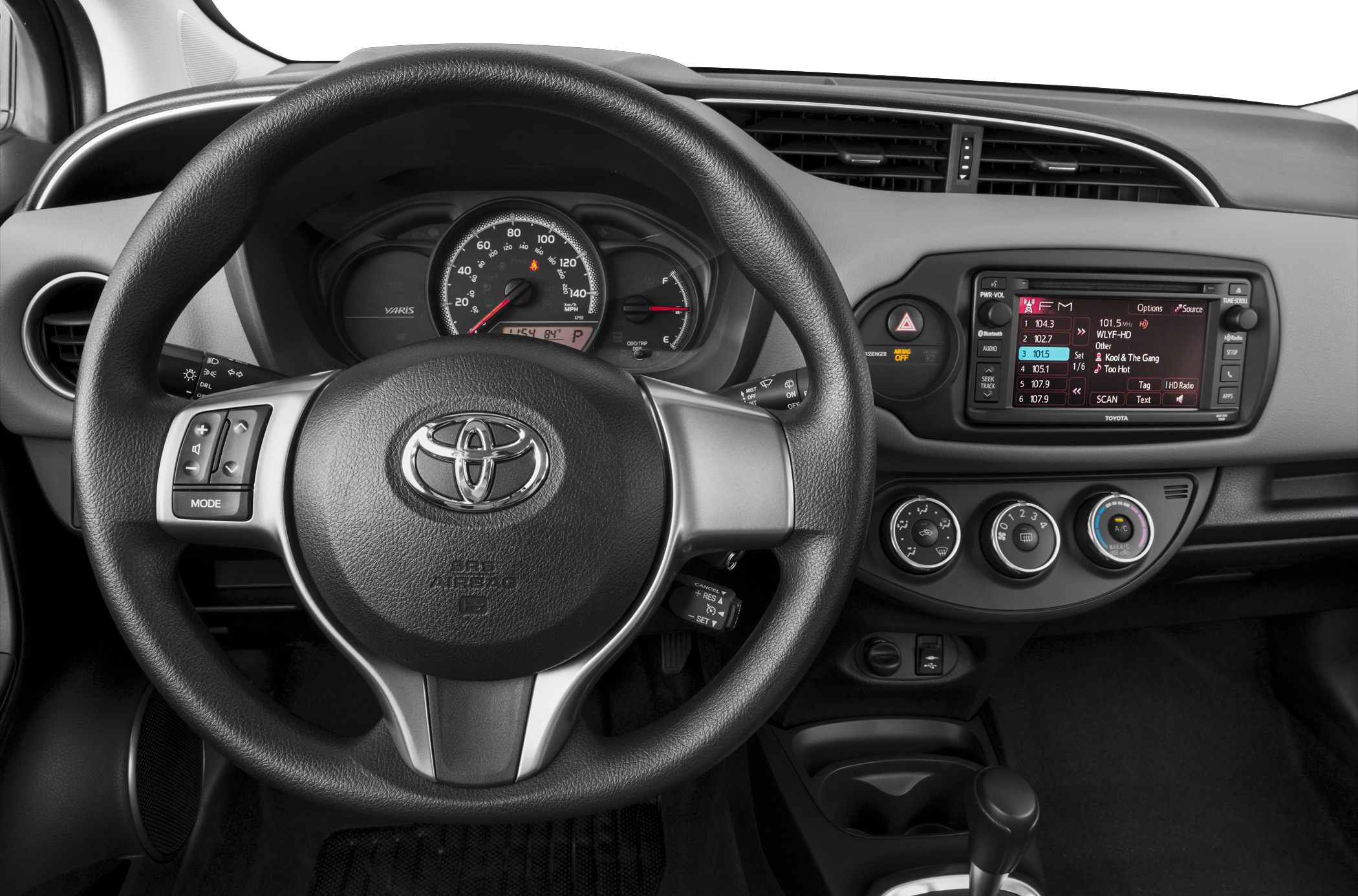 Steering wheel with controls, instrument cluster, and multimedia dashboard display.