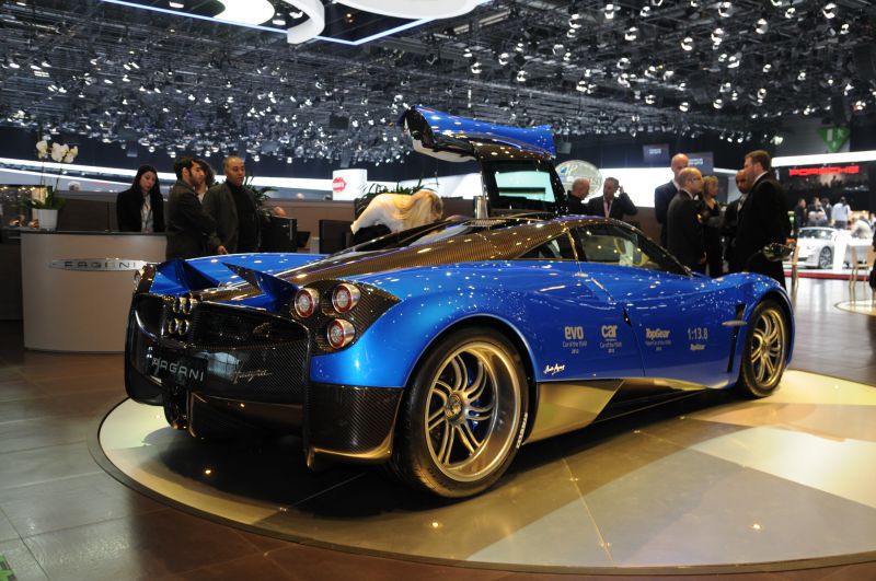 Rear side view with open gullwing door and carbon fiber detailing