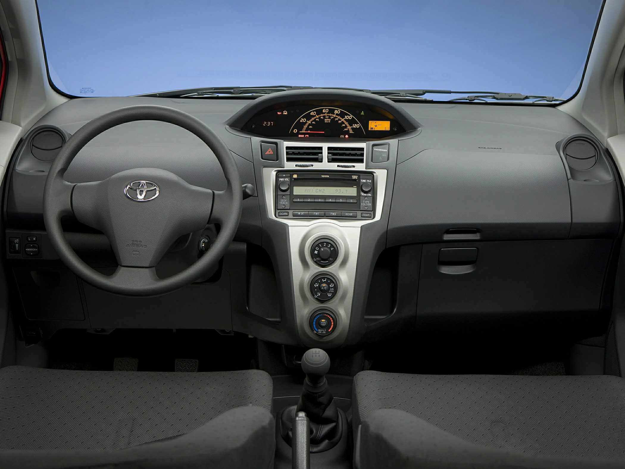 Dashboard and steering wheel with central control panel and manual gearshift