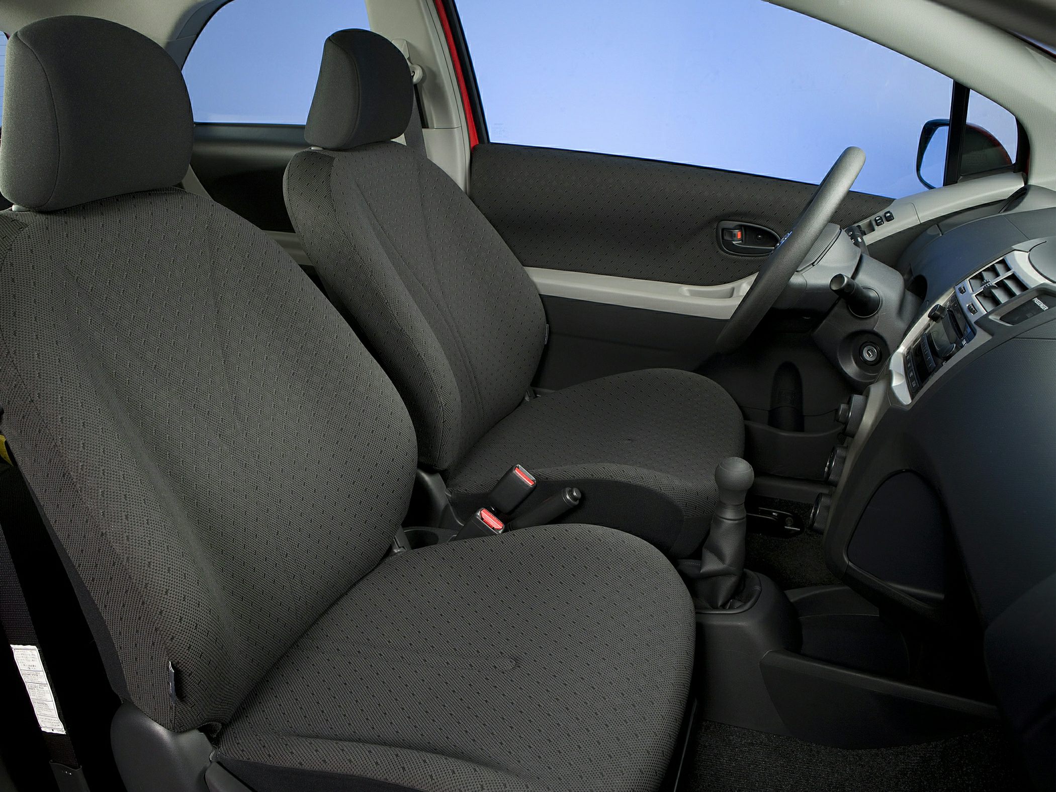 Black fabric seats with manual gear shift and simple dashboard