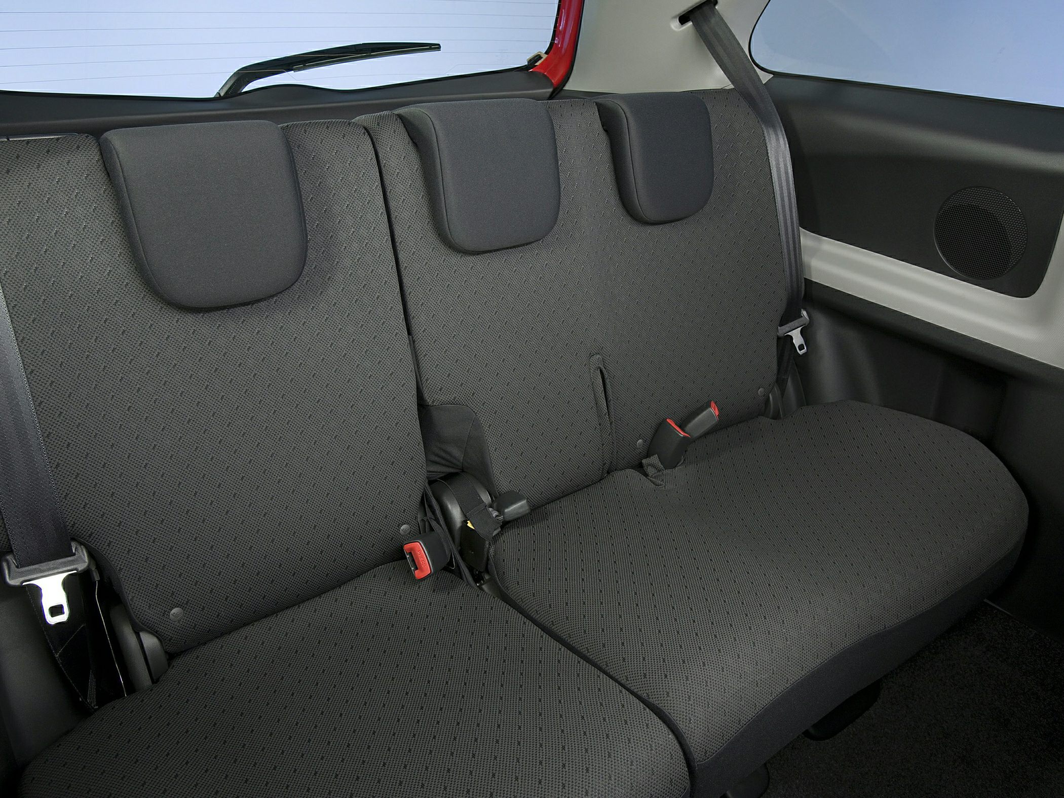 Rear fabric seats with headrests and seatbelts in compact car interior
