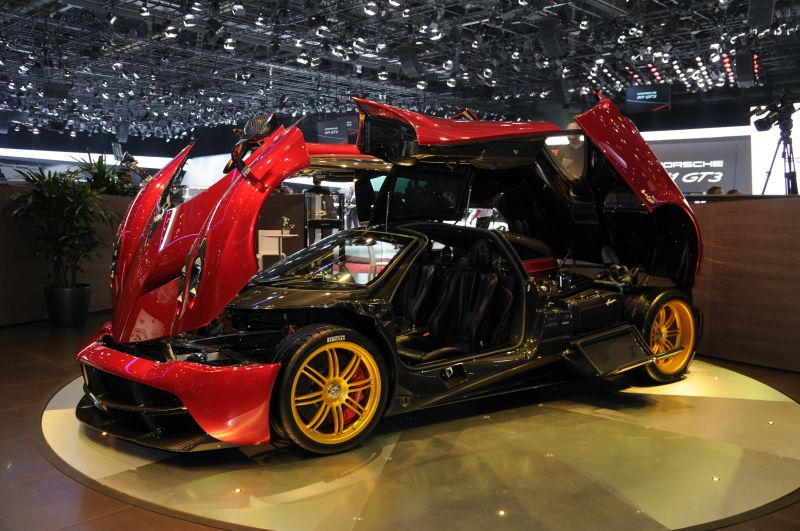 Open gullwing doors and rear engine cover on a high-performance sports car