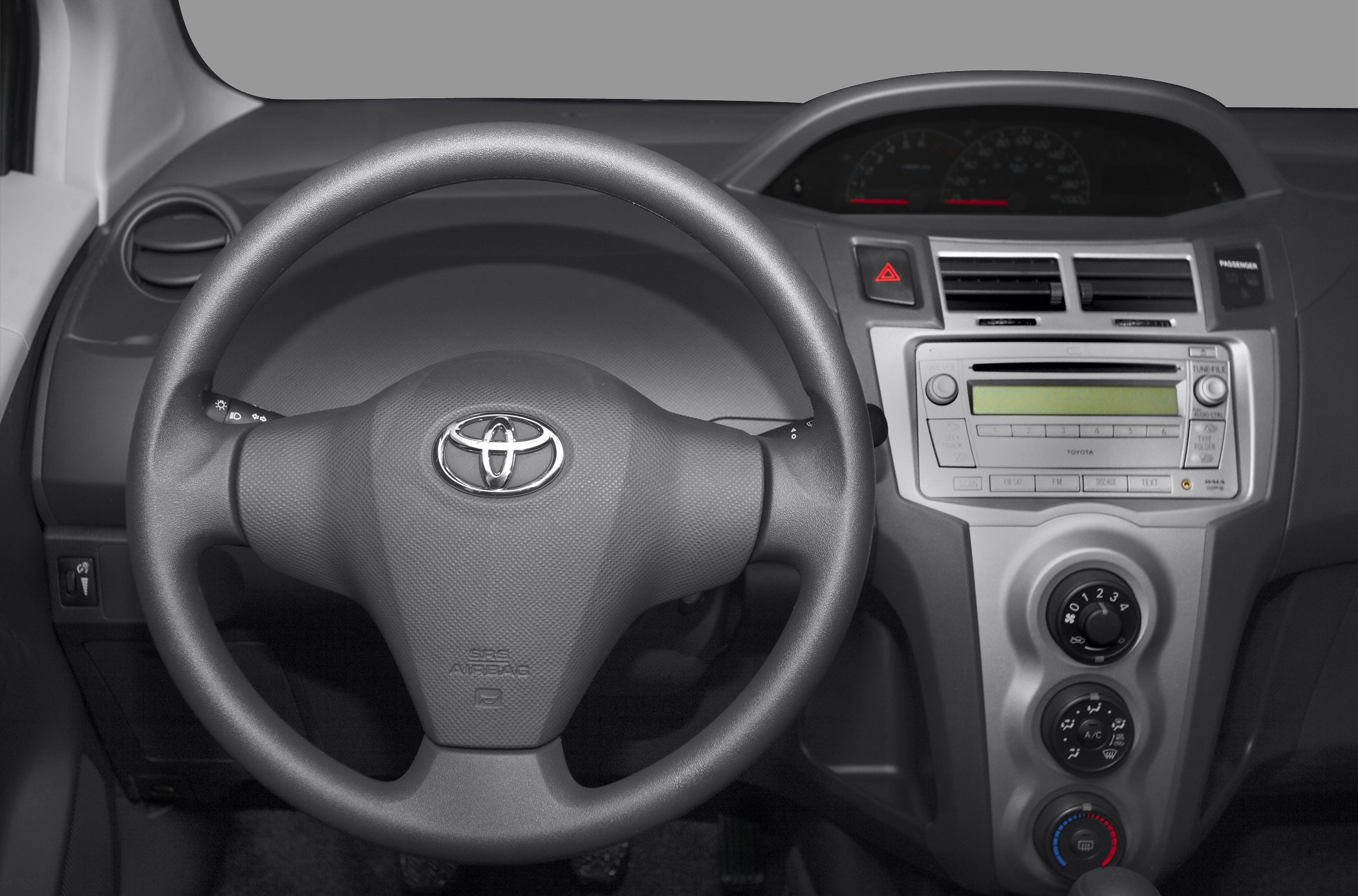 Steering wheel and dashboard with climate control and radio panel.