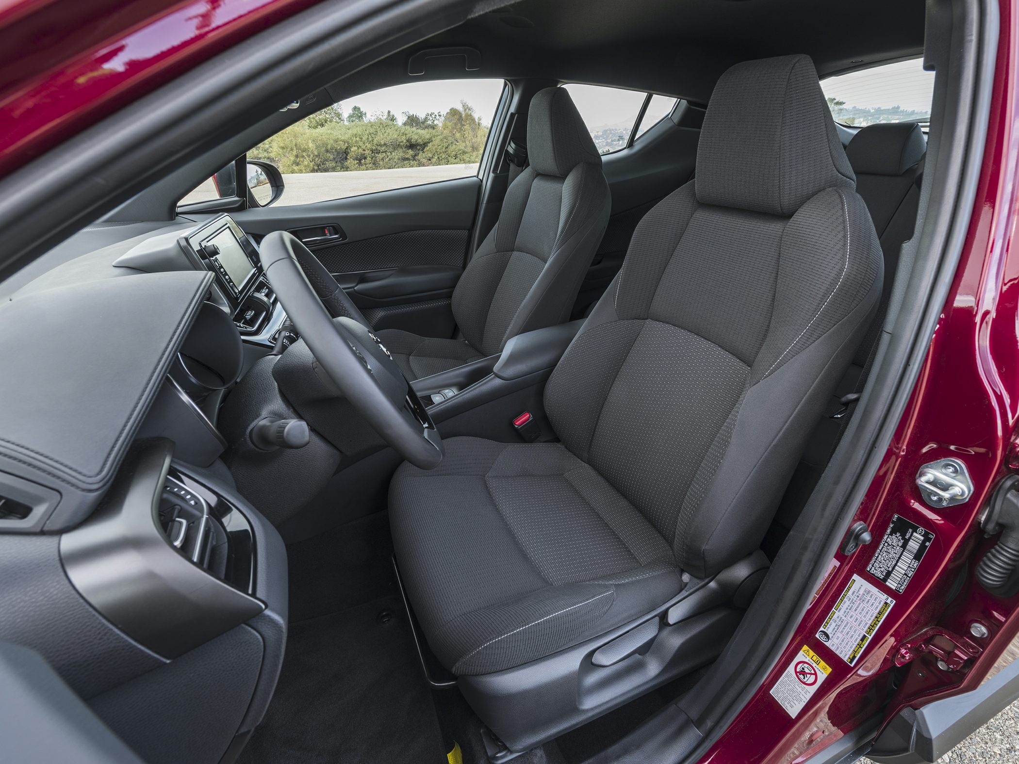 Front seats and dashboard interior view of compact car cabin