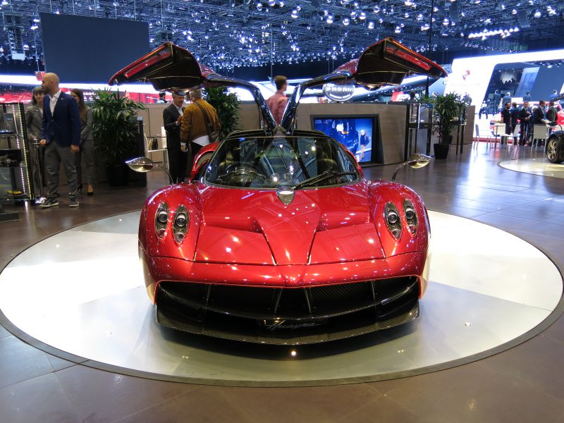 Red supercar with gullwing doors and aerodynamic front design