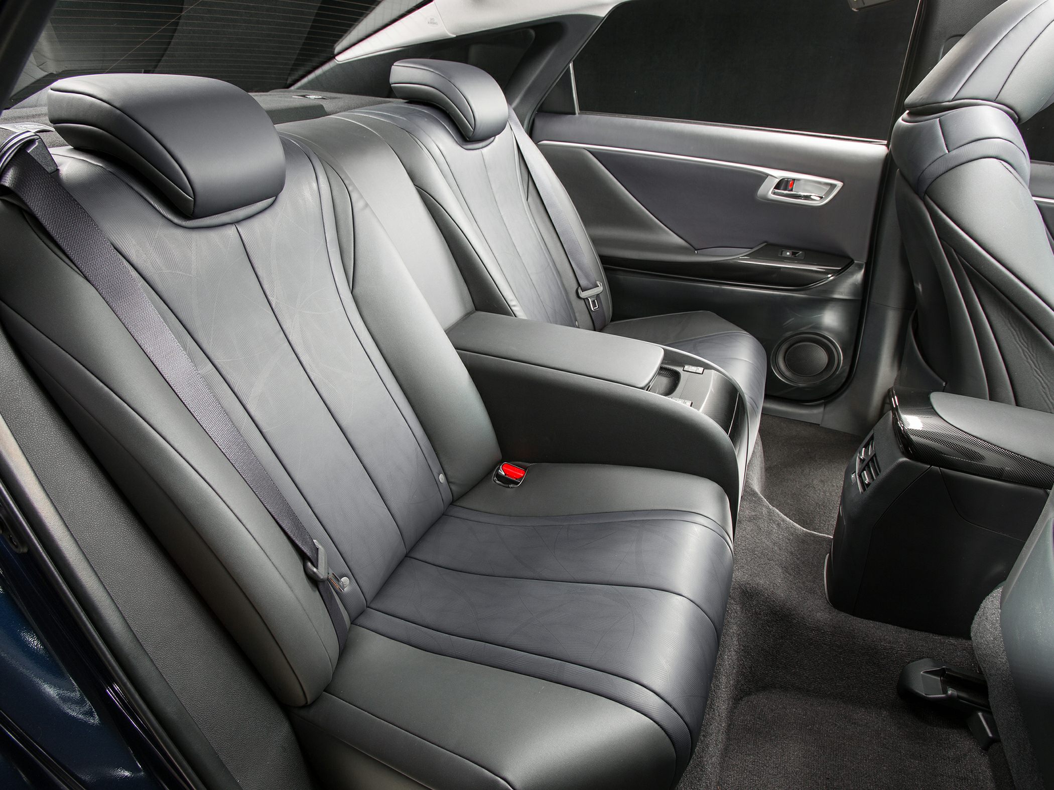 Rear car interior with leather upholstered seats and armrest