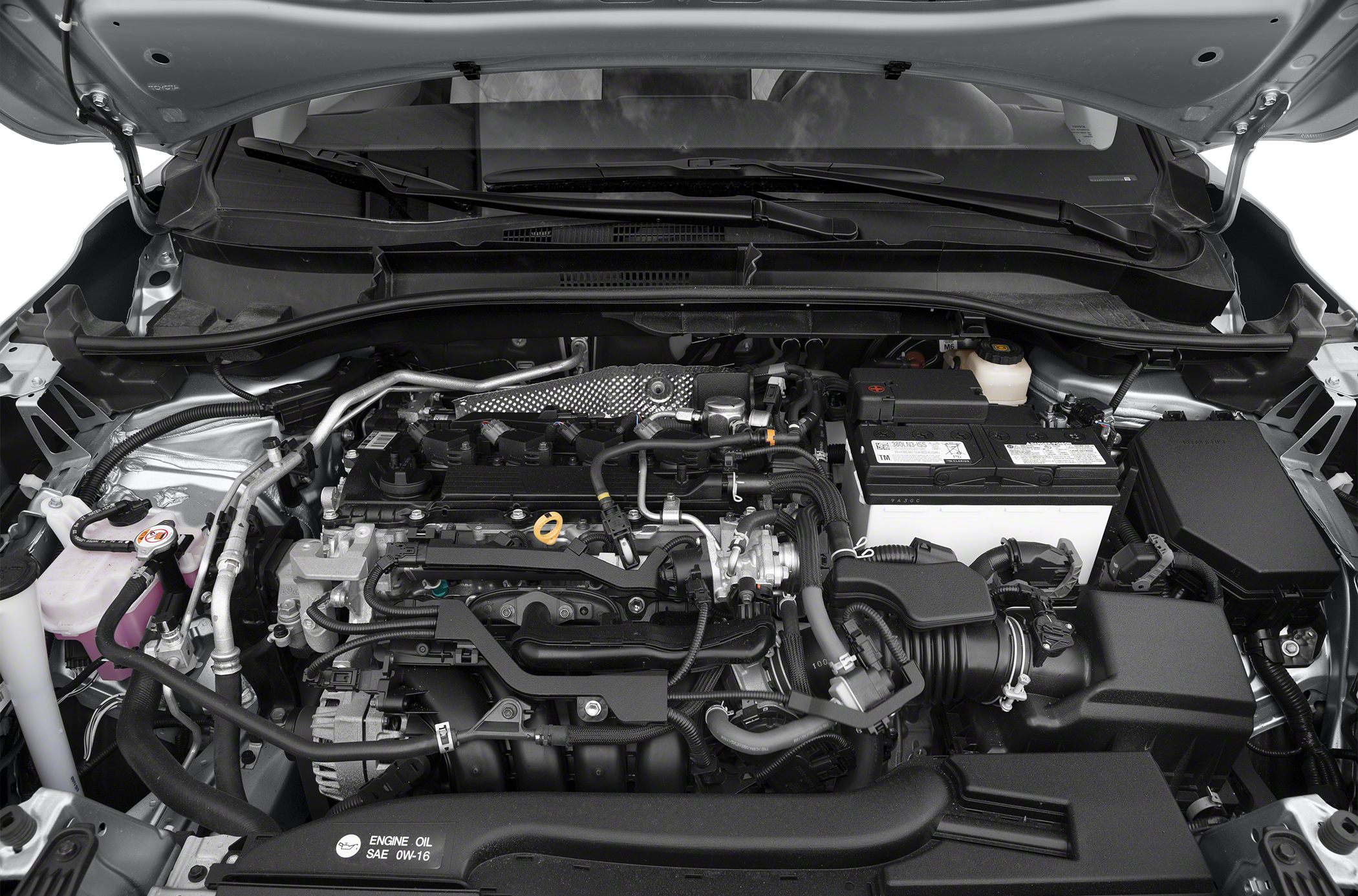 Engine bay with battery, air intake, cooling system, and wiring.