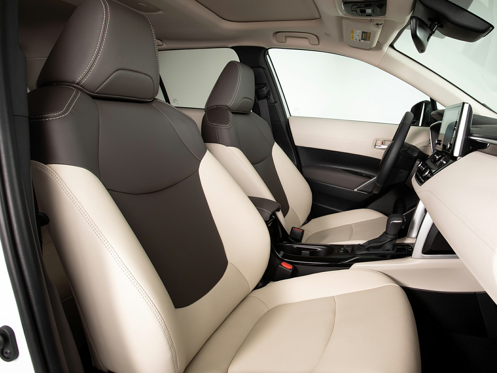 Beige and brown front seats with modern dashboard and infotainment screen