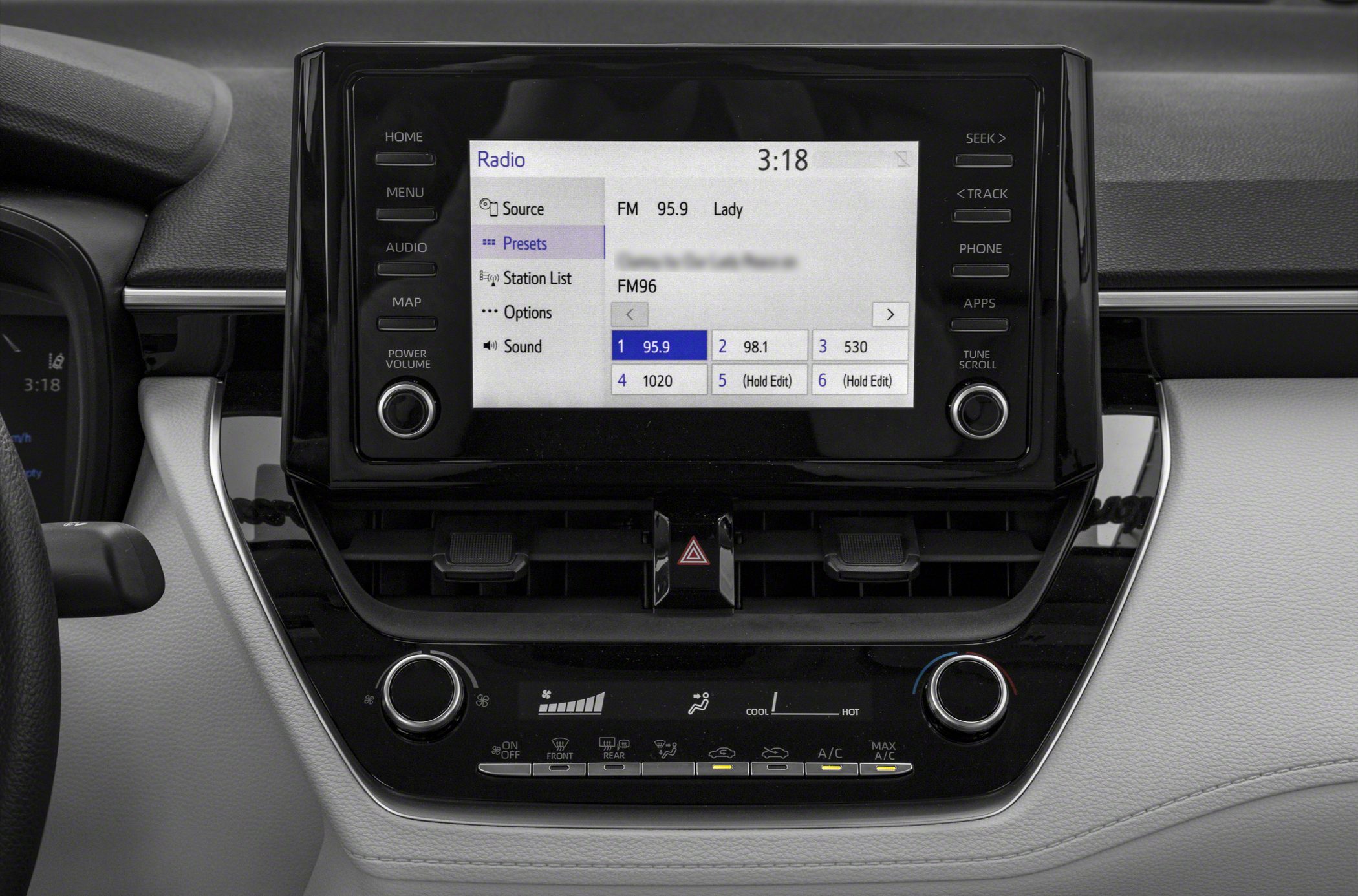 Touchscreen infotainment display with radio presets and rotary climate control knobs