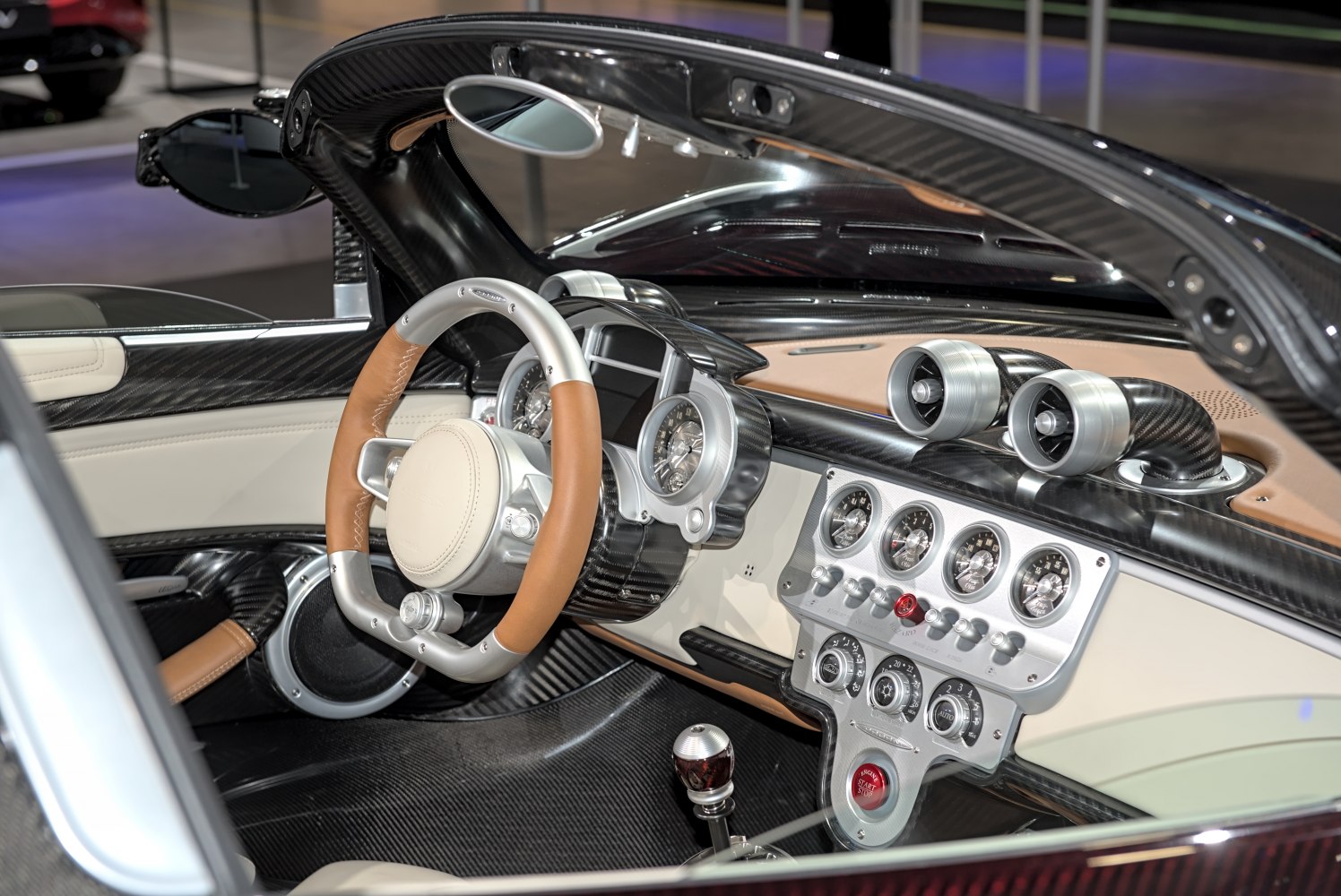 Carbon fiber interior with analog gauges and unique control knobs.
