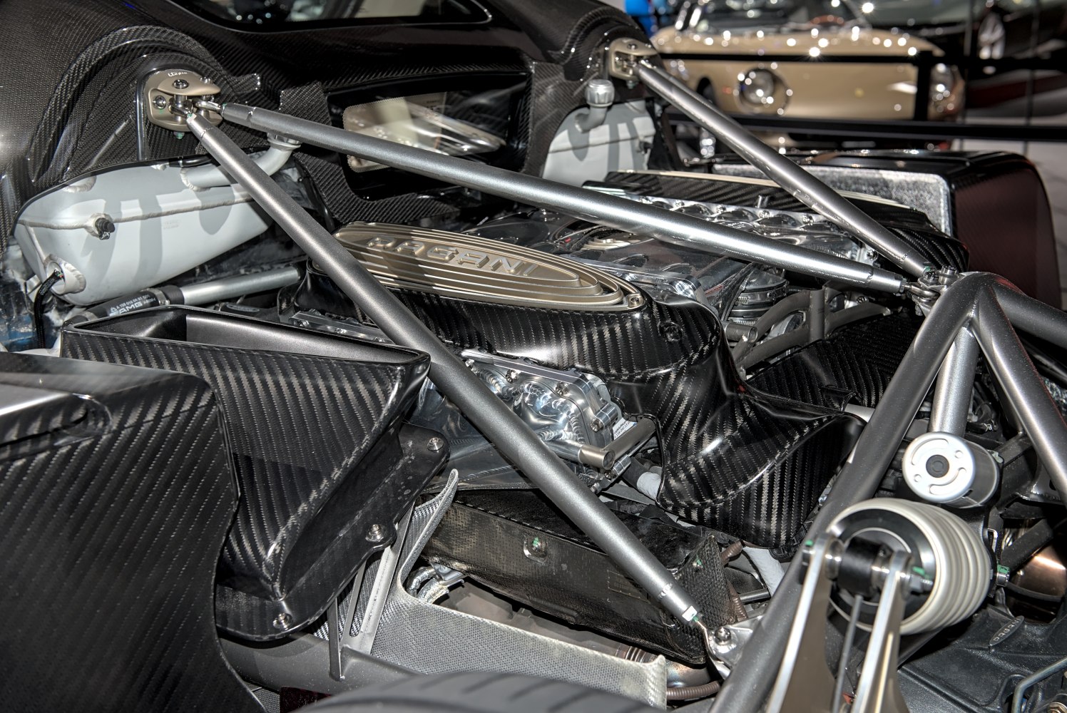 Close-up of supercar engine bay with carbon fiber and structural braces