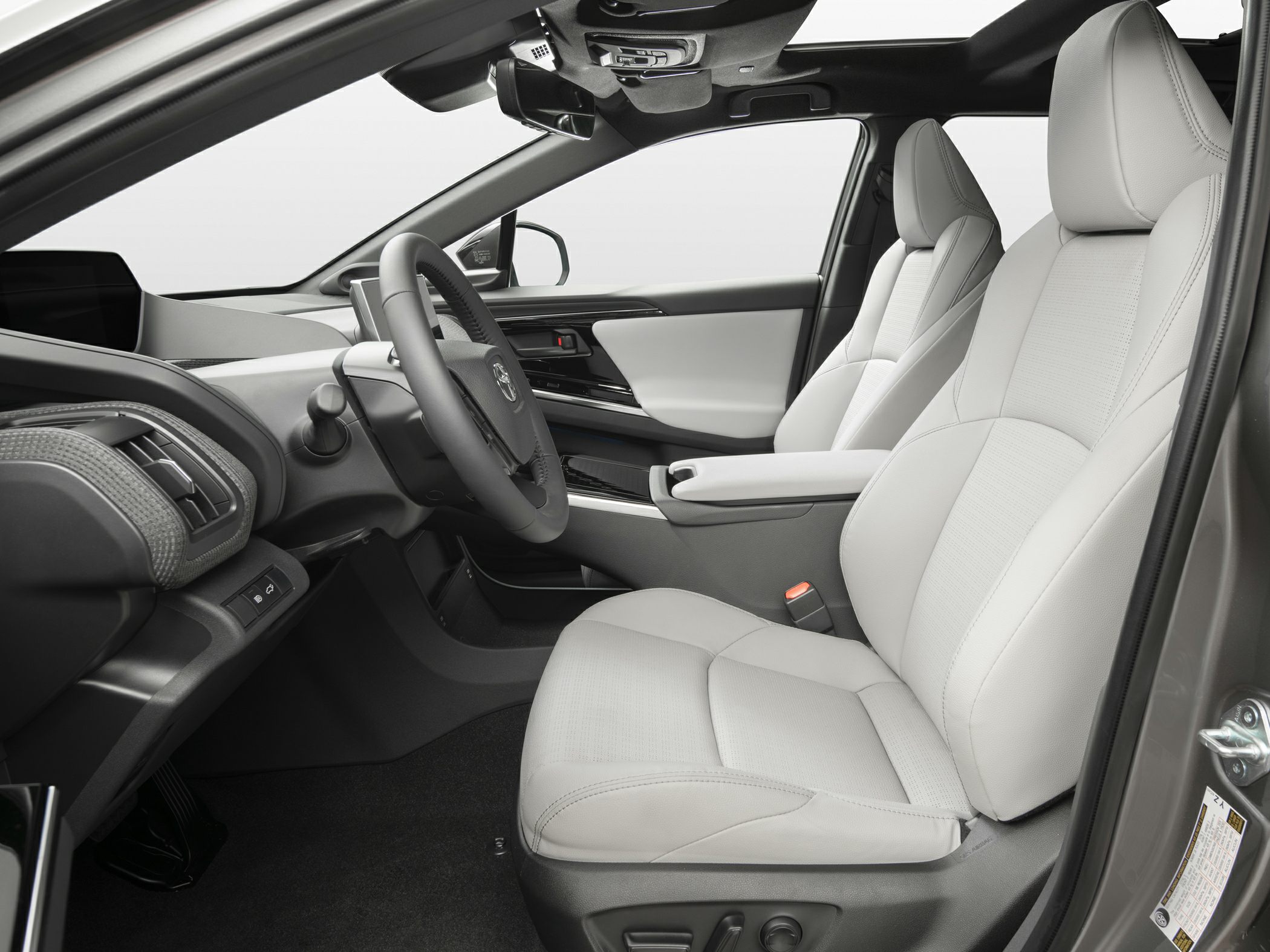 Spacious front seats with modern cockpit and steering wheel layout