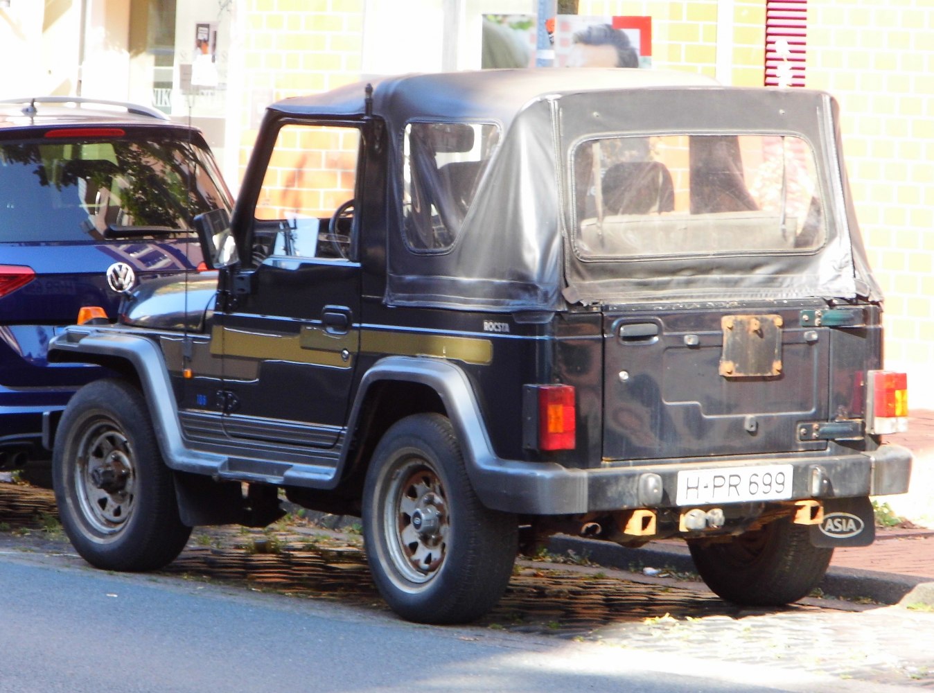 Black soft-top off-road vehicle rear with rugged design and square tail lights