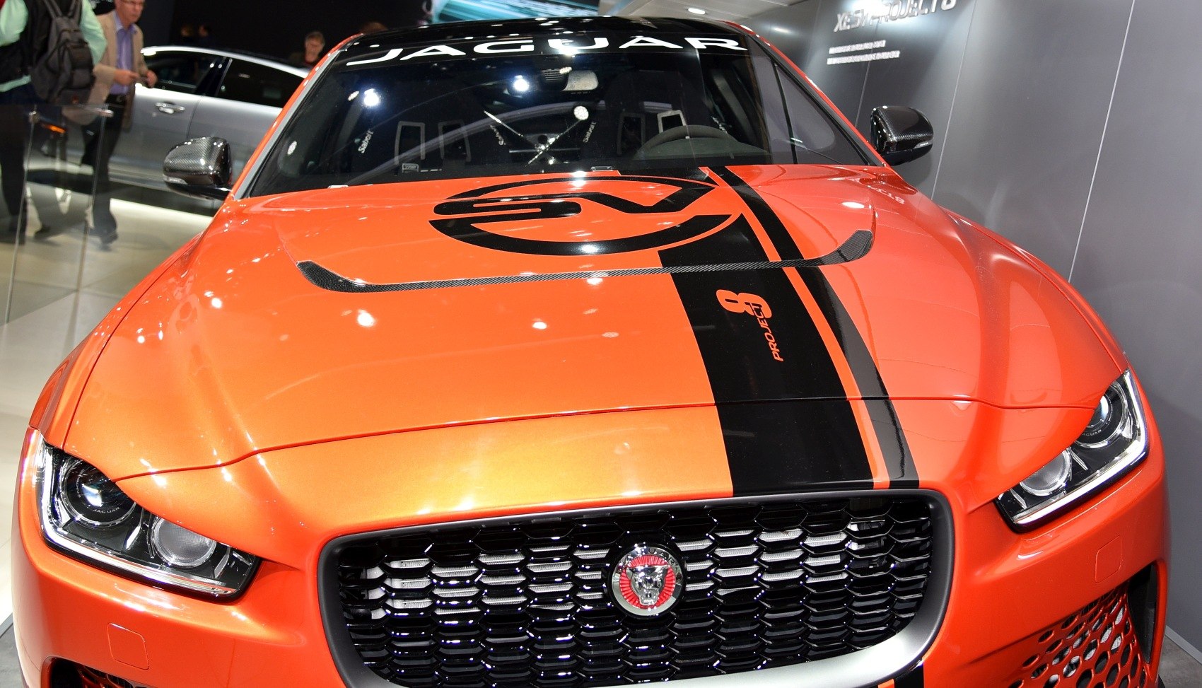 Closeup of front grille, headlights, and hood with bold racing stripe