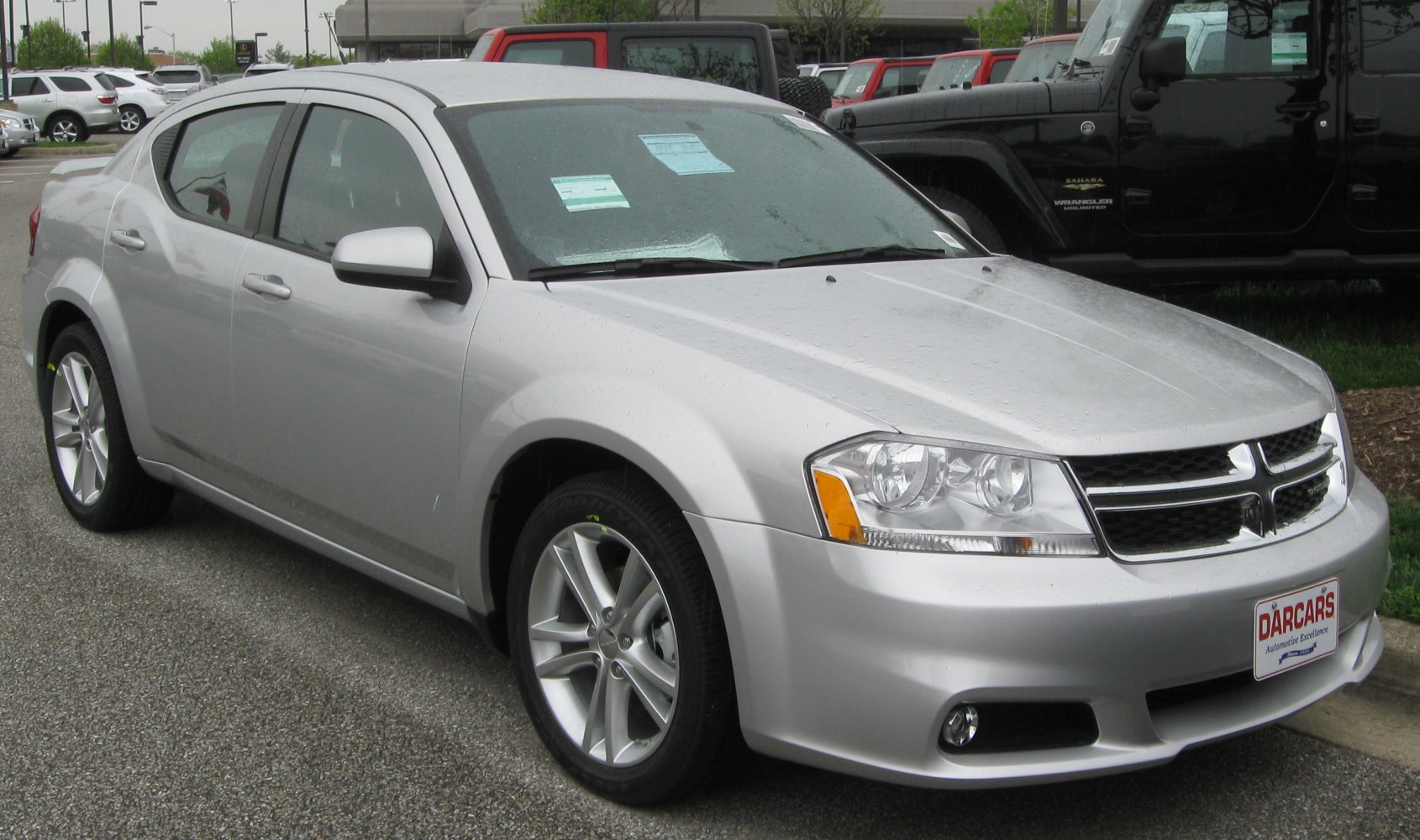 Silver sedan front side with alloy wheels and grille