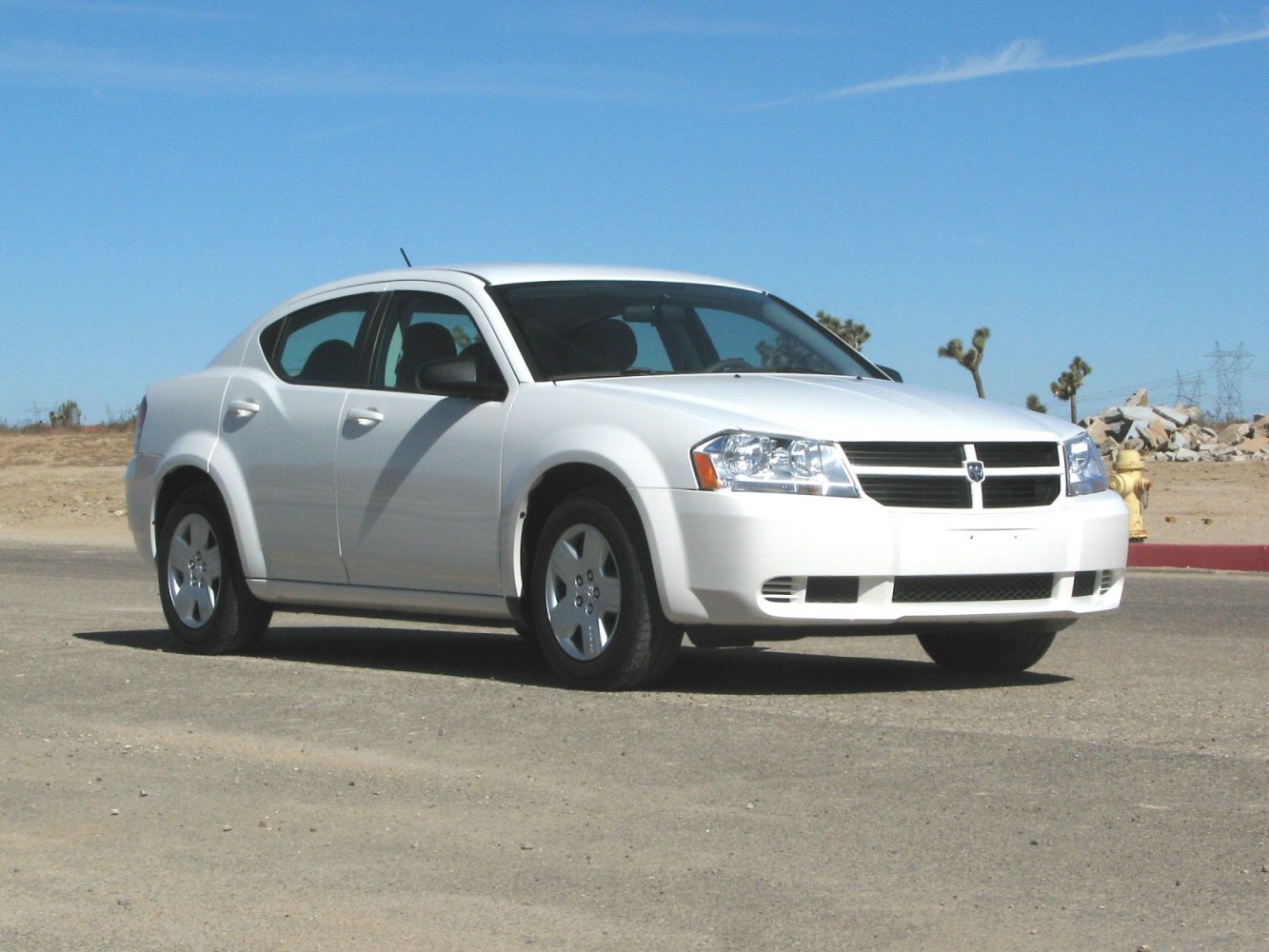 White mid-size sedan with distinct front grille and four doors