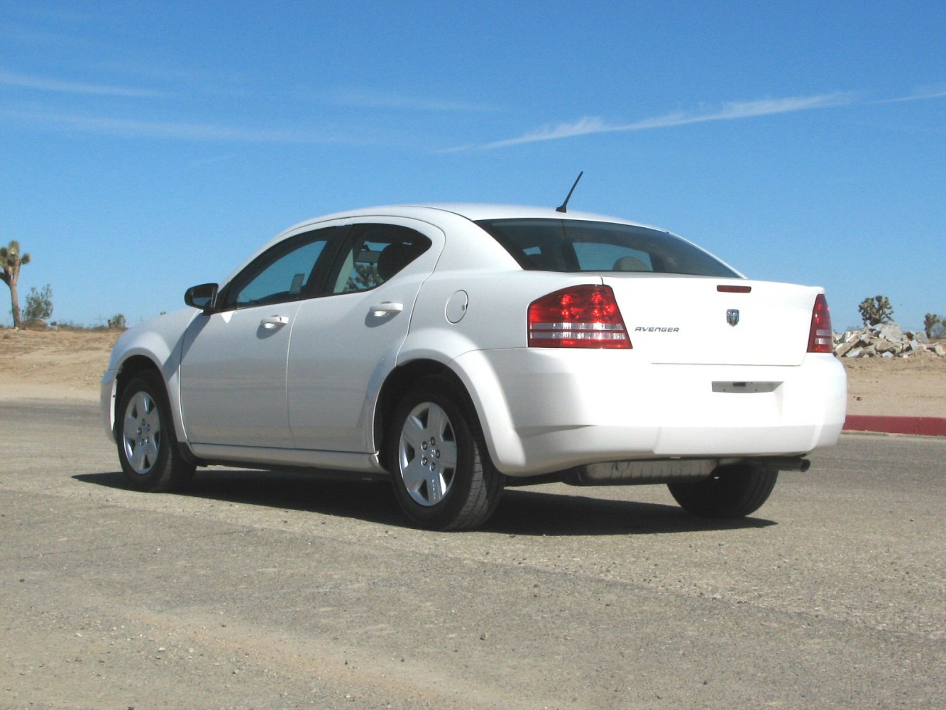 Rear side view of a four-door midsize sedan with distinct tail lights.