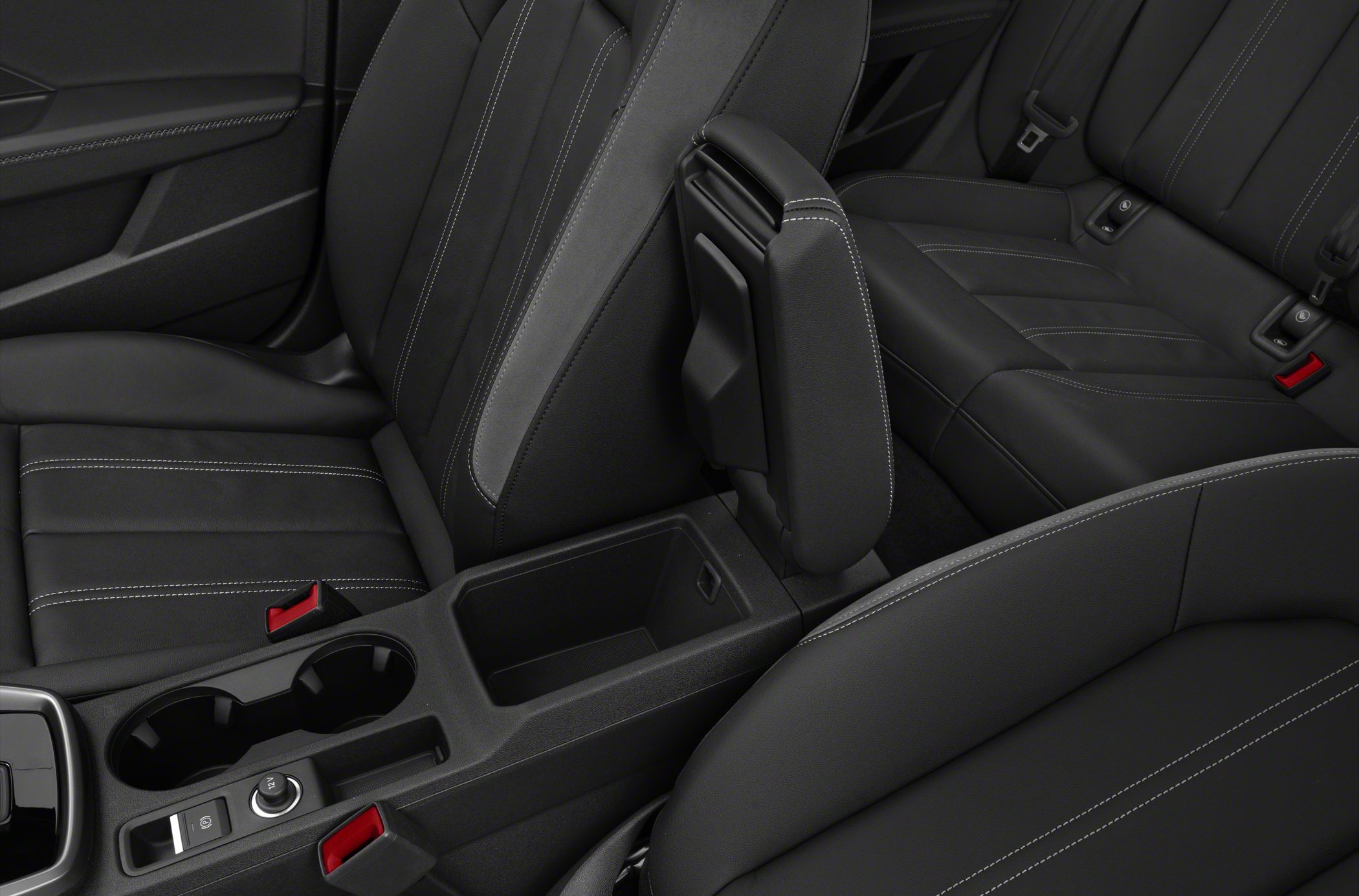 Black leather seats with white stitching and center console with cup holders
