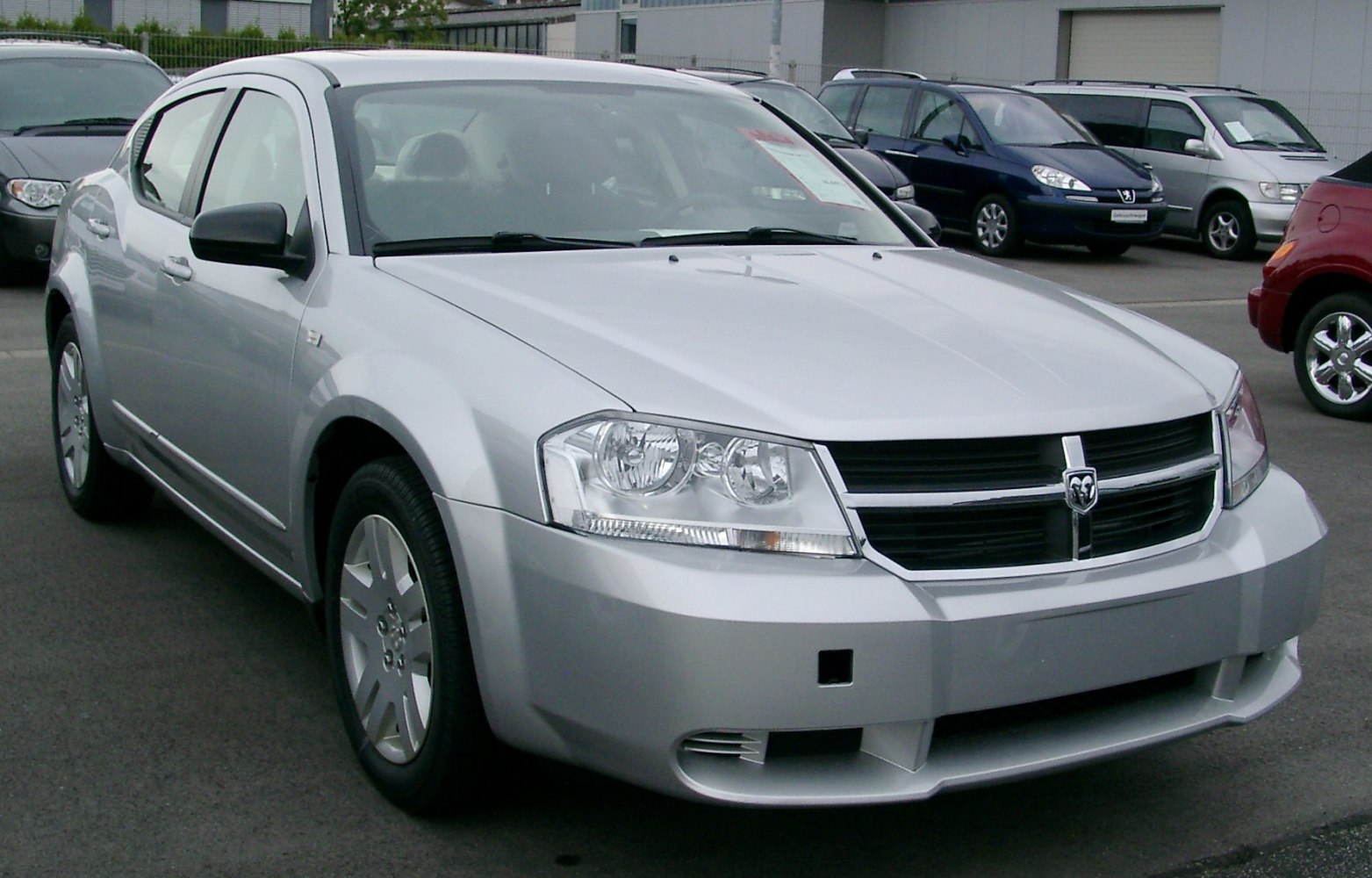 Sedan front and side view with headlights, grille, and alloy wheels