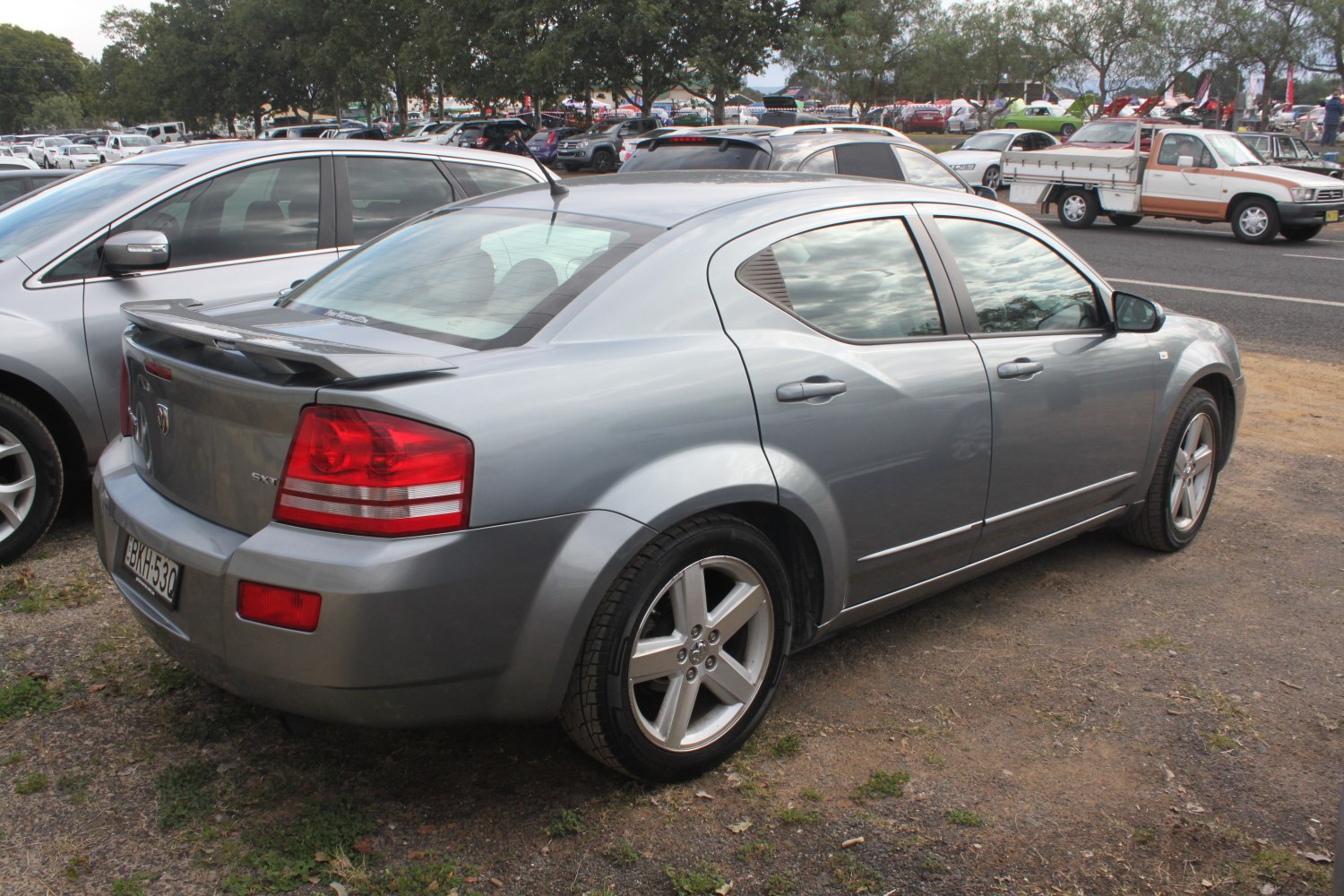 Rear-side view of a sedan with rear spoiler and alloy wheels