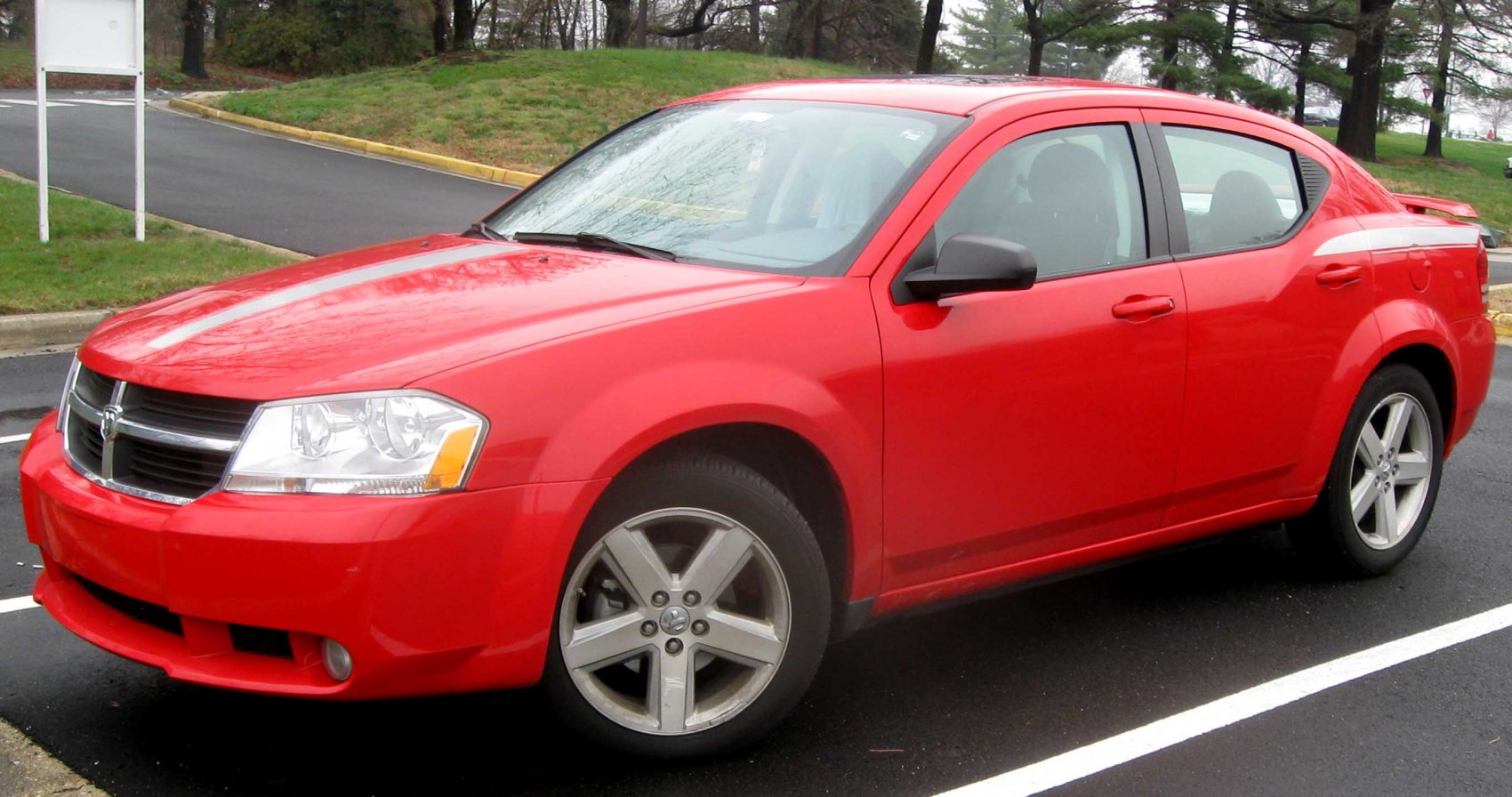 Front and side profile of red four-door sedan with alloy wheels