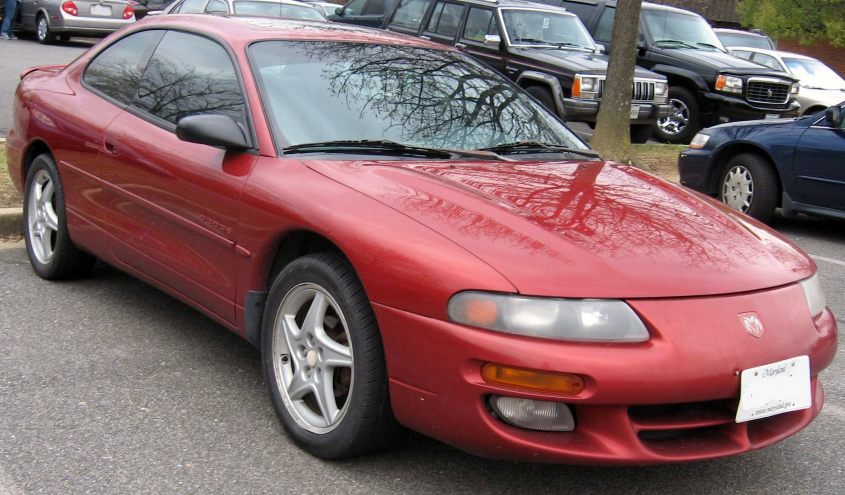 Sporty red two-door coupe with rounded headlights and aerodynamic design